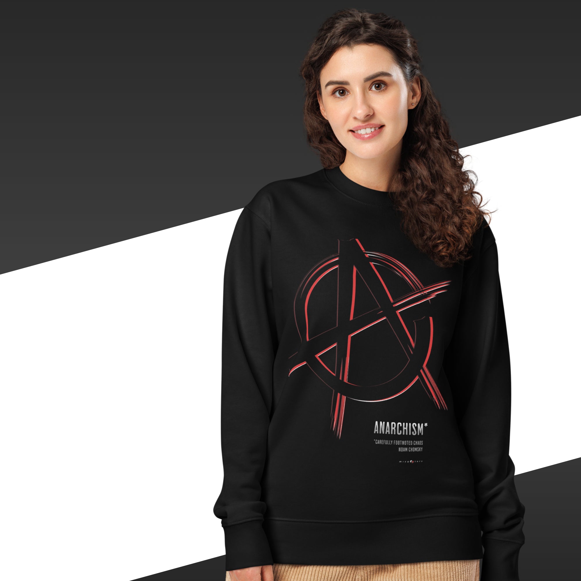 Person wearing a black sweatshirt with an anarchy symbol design on a black and white background