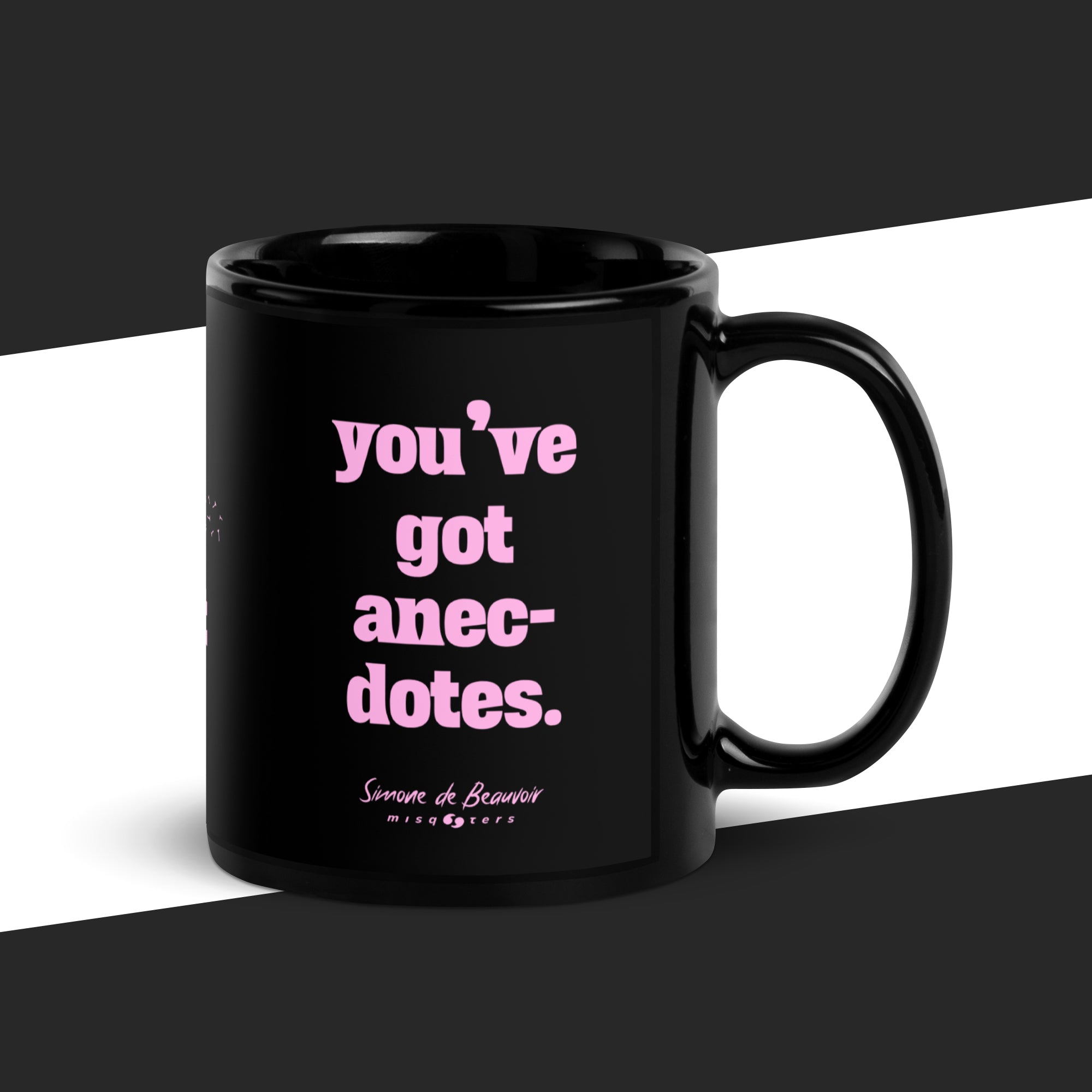 Black mug with pink text 'you've got anecdotes.' on a black and white background