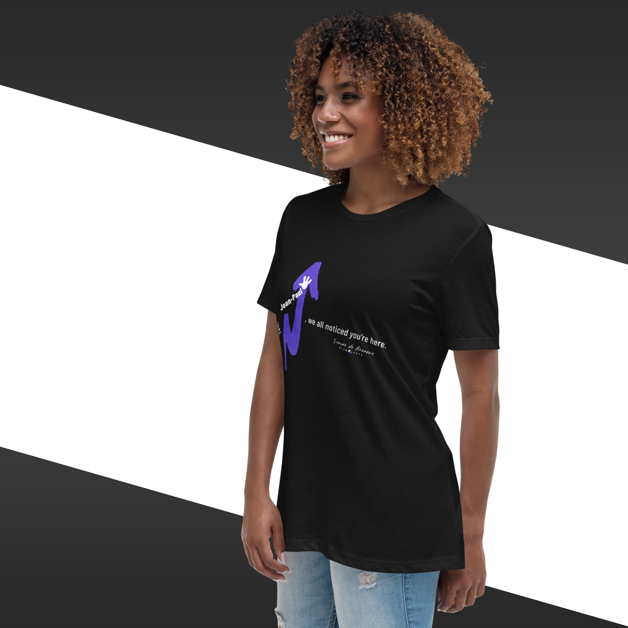 Person wearing a black t-shirt with a purple graphic and text on a black and white background