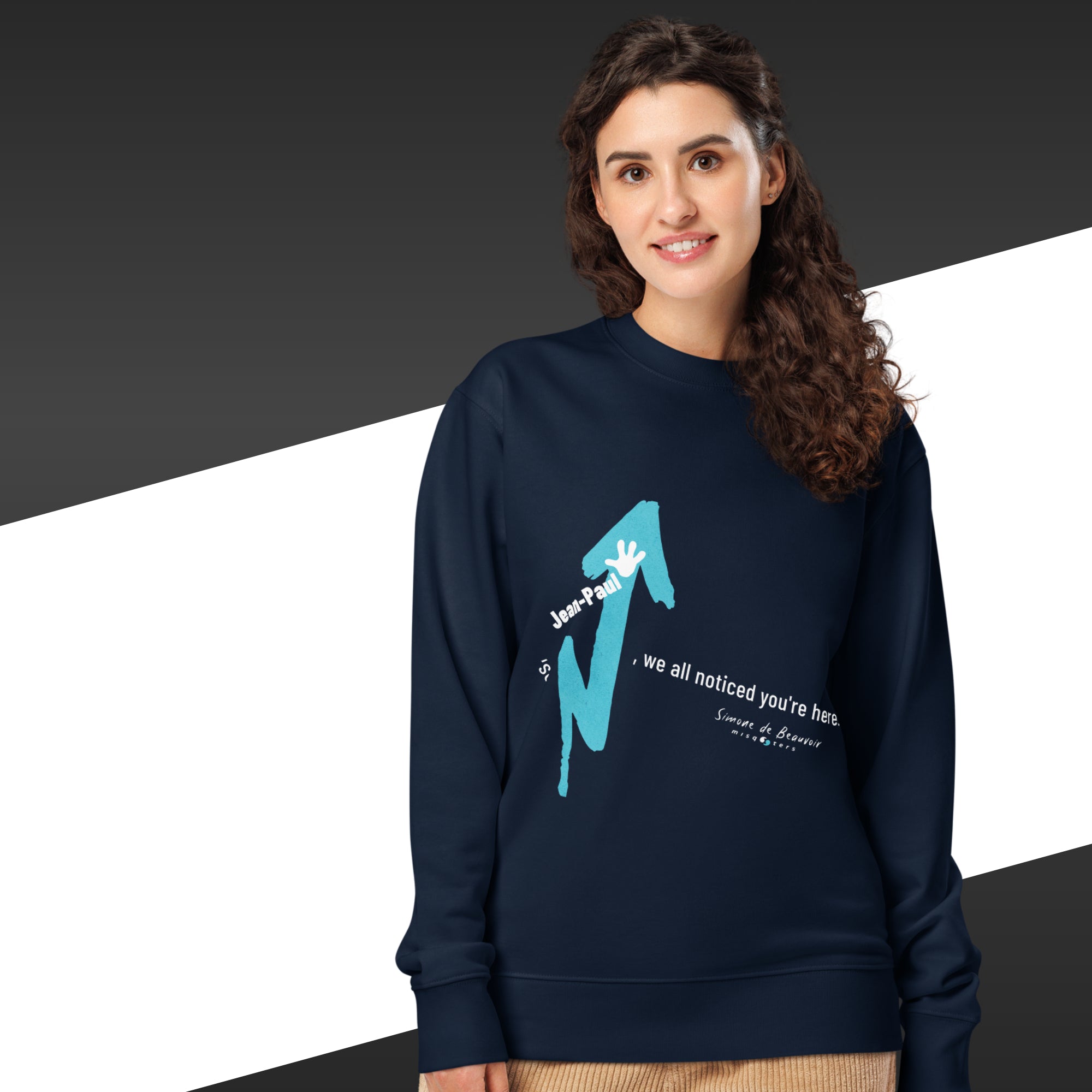 Woman wearing a navy blue sweatshirt with a graphic design on a black and white background