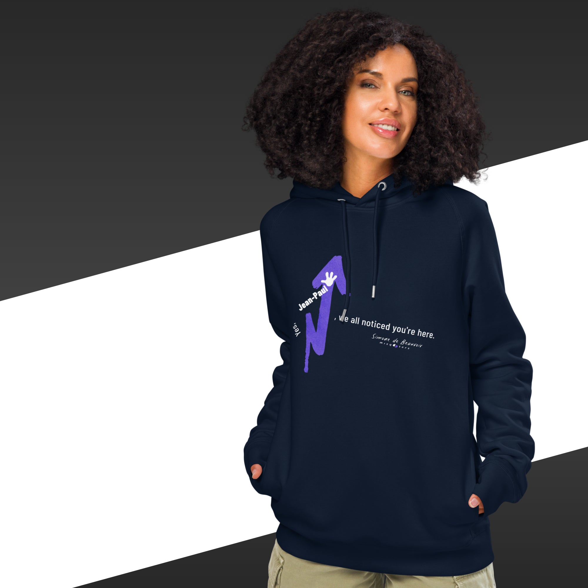 Person wearing a navy blue hoodie with a graphic design on a black and white background