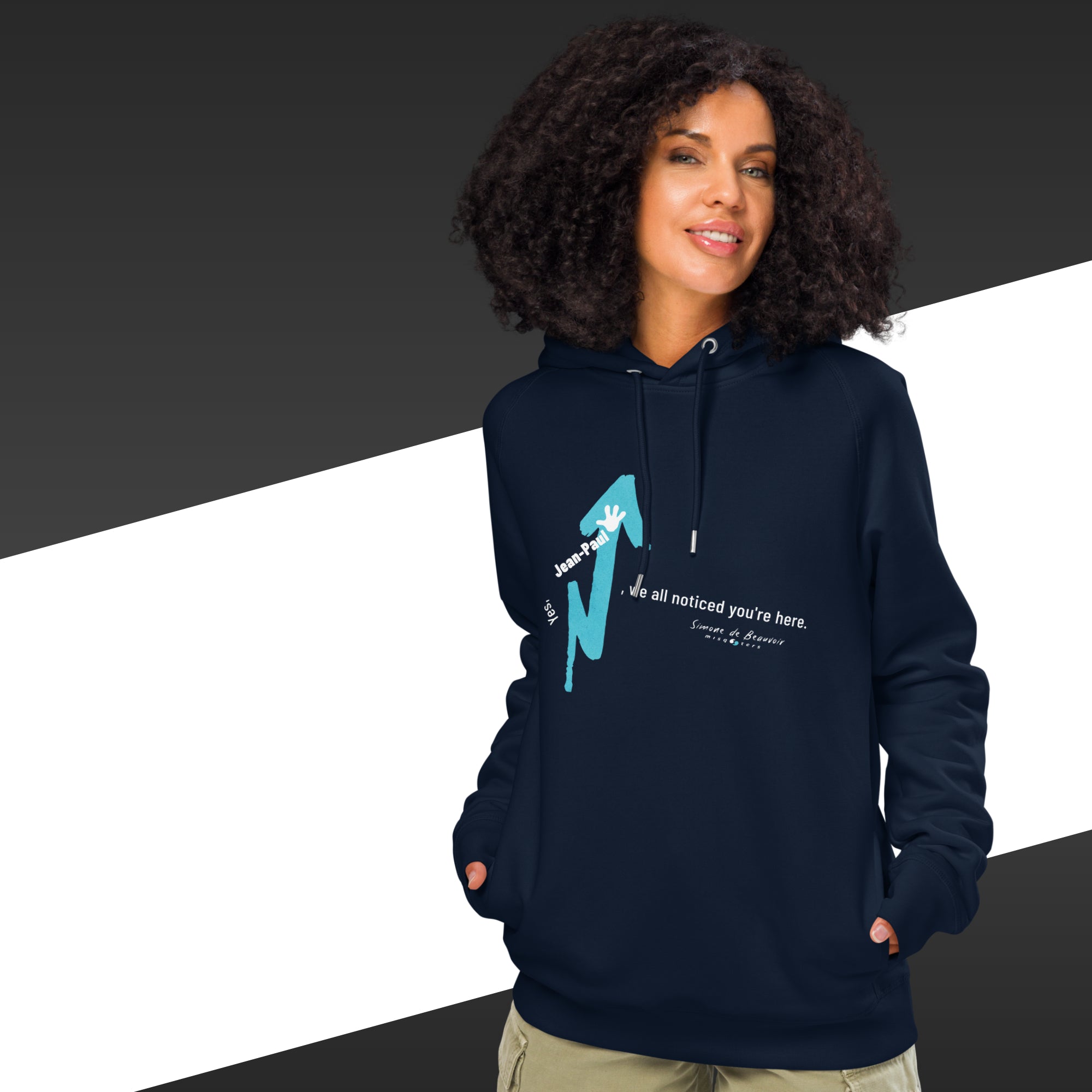 Person wearing a navy blue hoodie with a graphic design on a black and white background