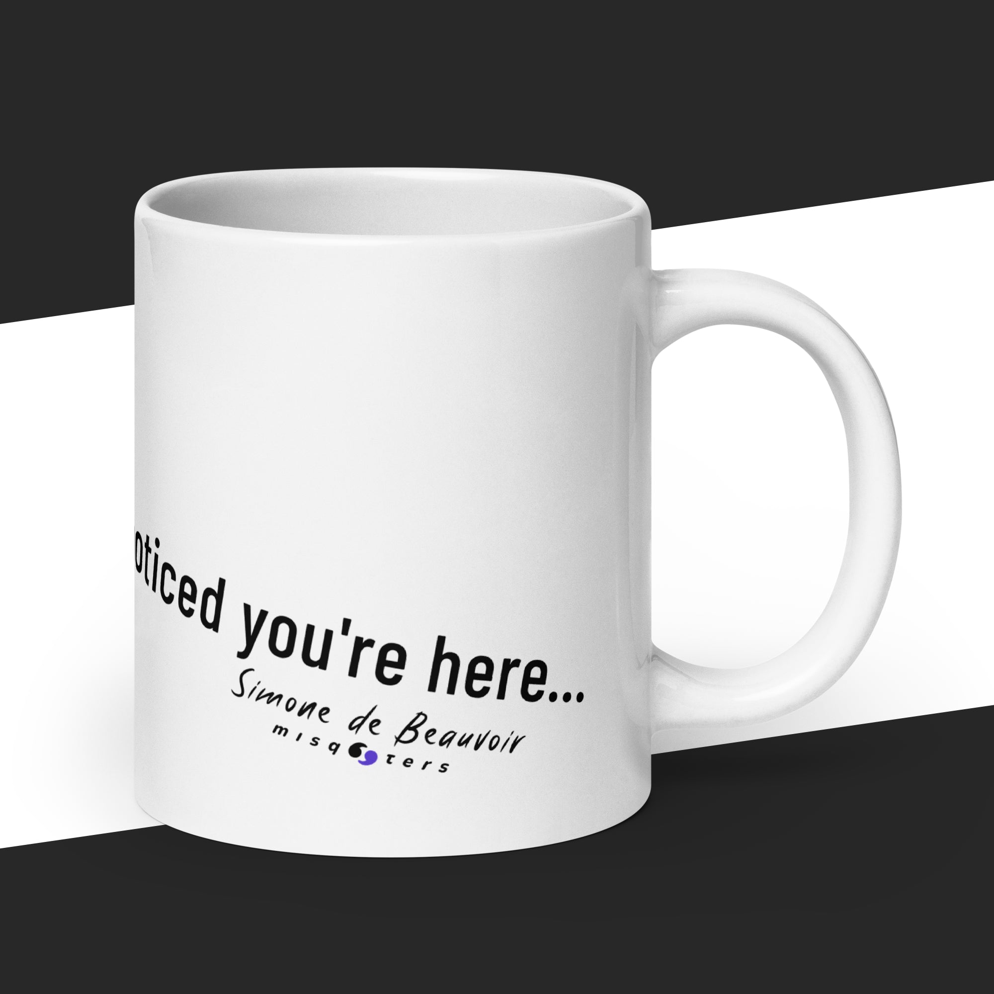 white mug with some text and the logo of misquoters on it on a black and white striped background