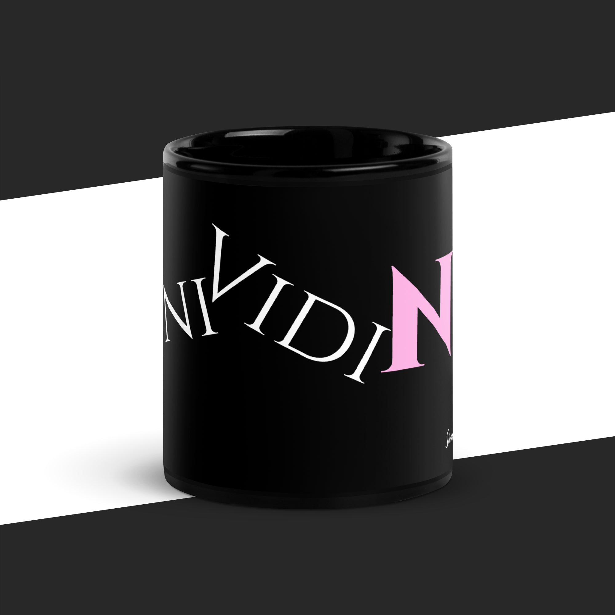 Black mug with text on a white and black striped background