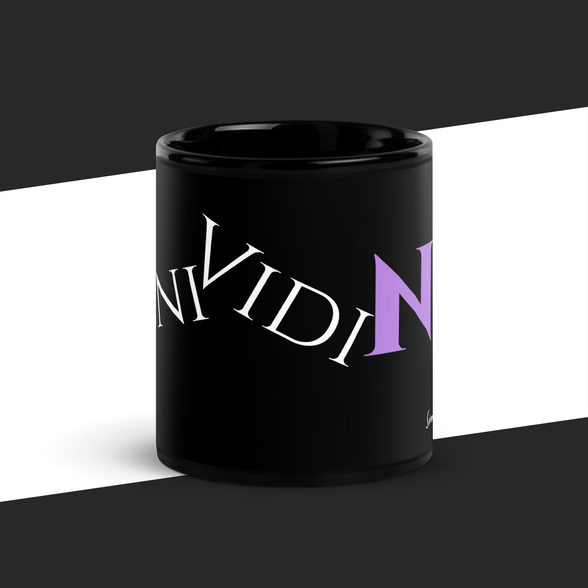 Black mug with pruple graphic on a white and black striped background