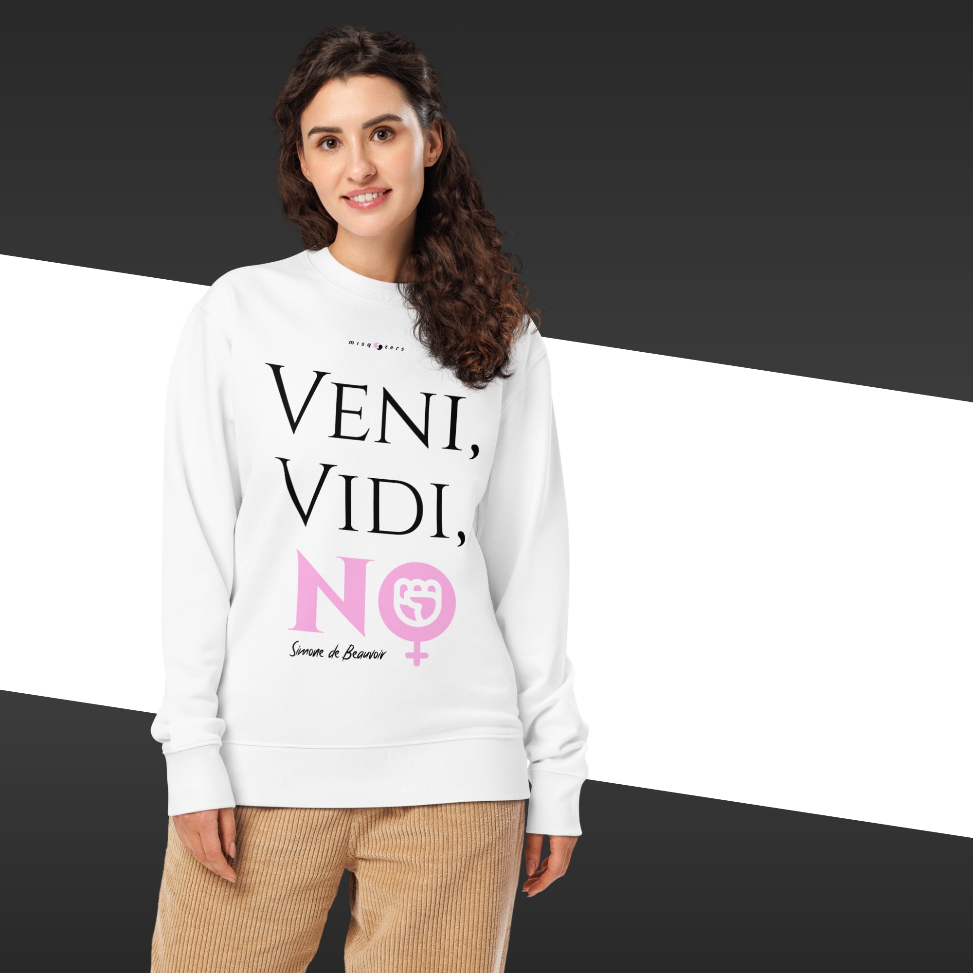 Woman wearing a white sweatshirt with text and a logo on a black and white striped background