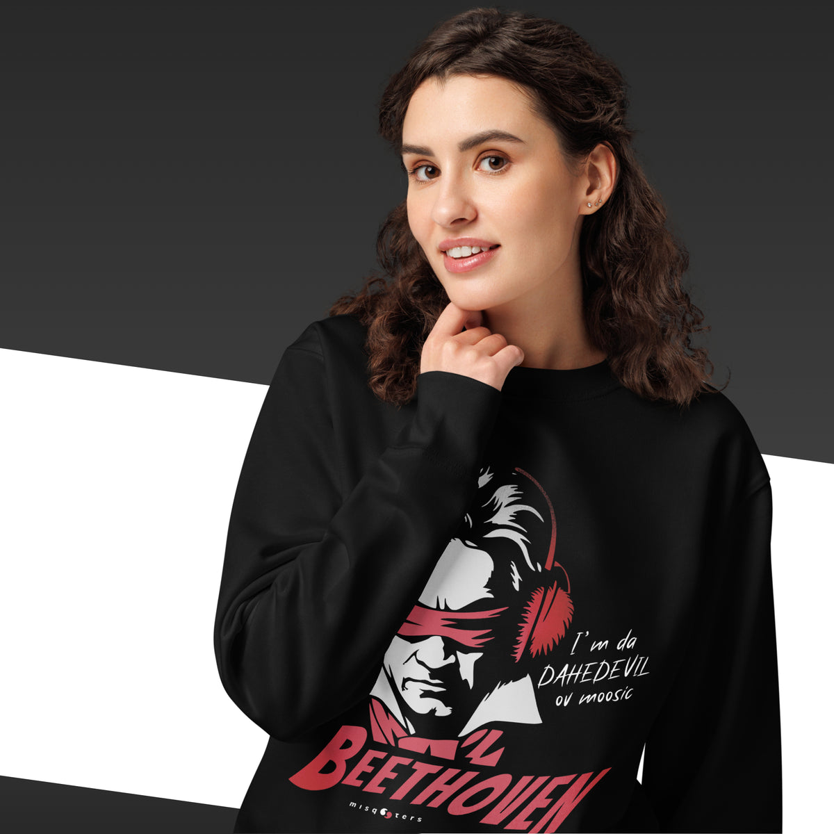 Person wearing a black hoodie with a graphic design and text on a dark background