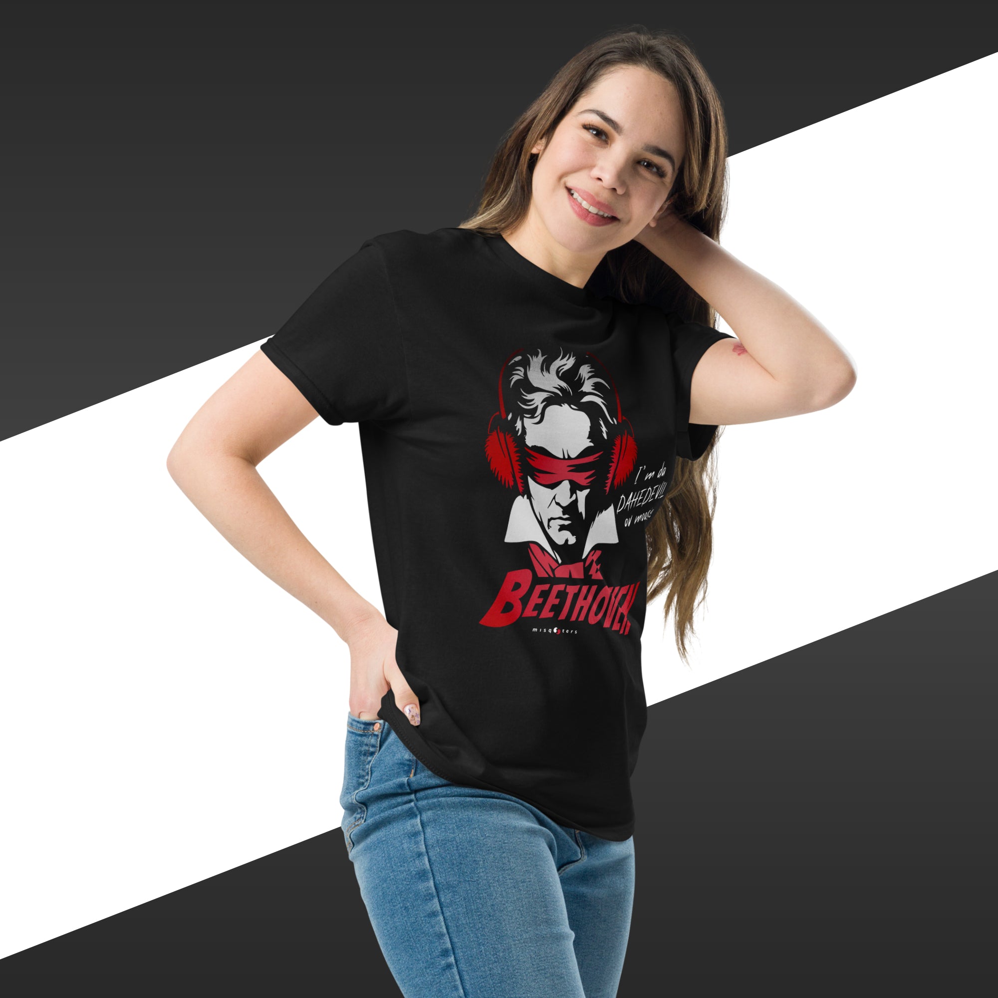 Woman wearing a black t-shirt with a graphic design on a white and black striped background