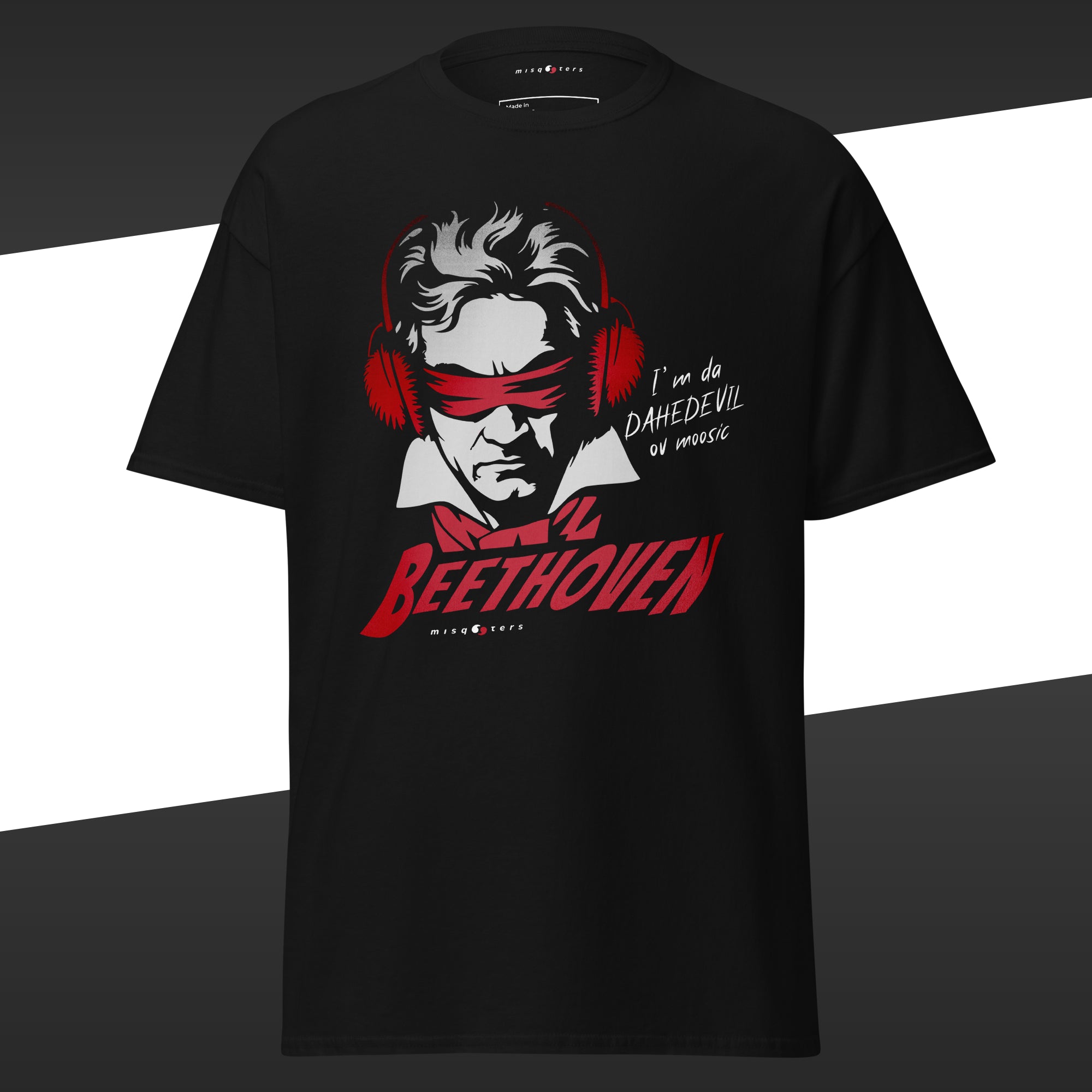 Black t-shirt with a red and white graphic of Beethoven wearing ear protectors, is blidnfolded, and featuring the fake quote "I´m da Dahedevil ov moosic" by Beethoven