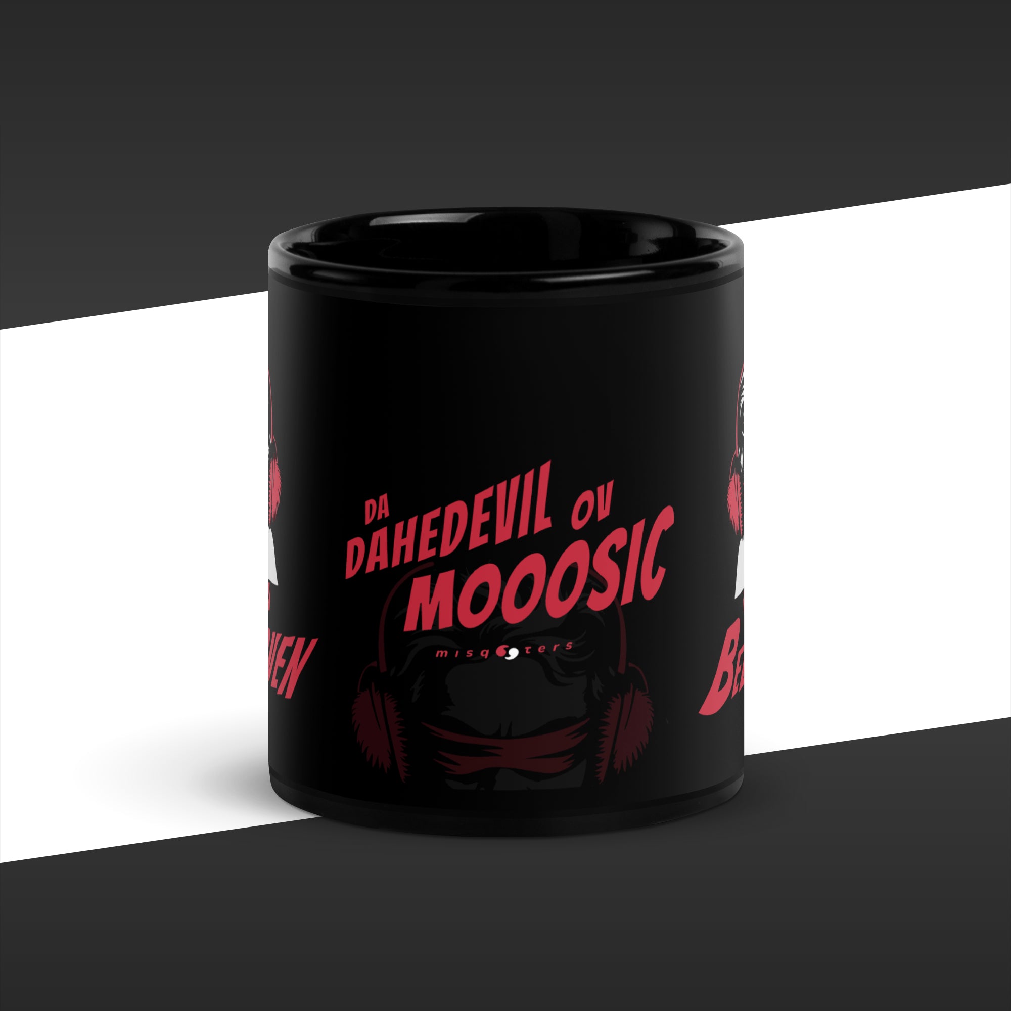 Black mug with red text and graphic design on a white and black striped background