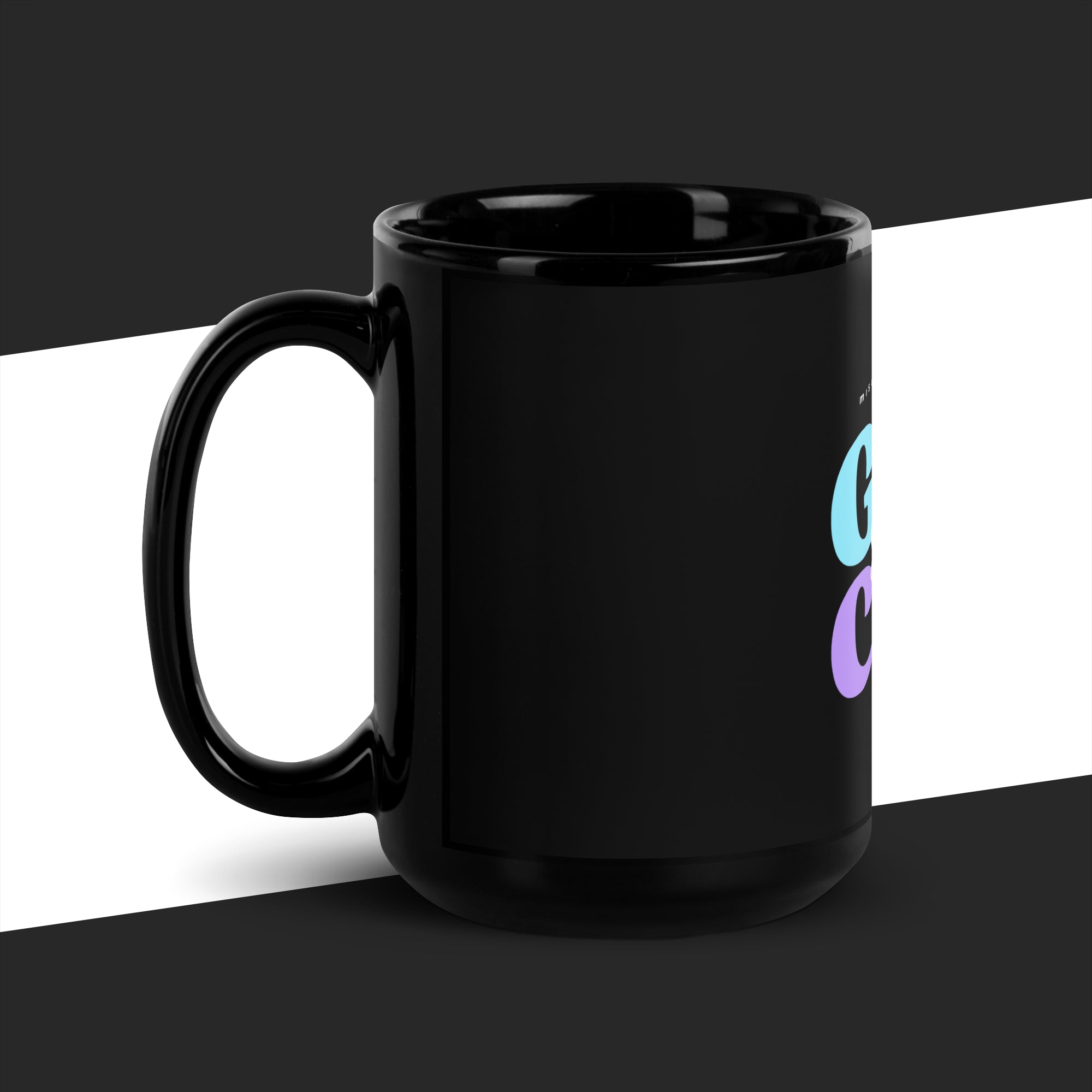 Black mug with colorful design on a black and white background