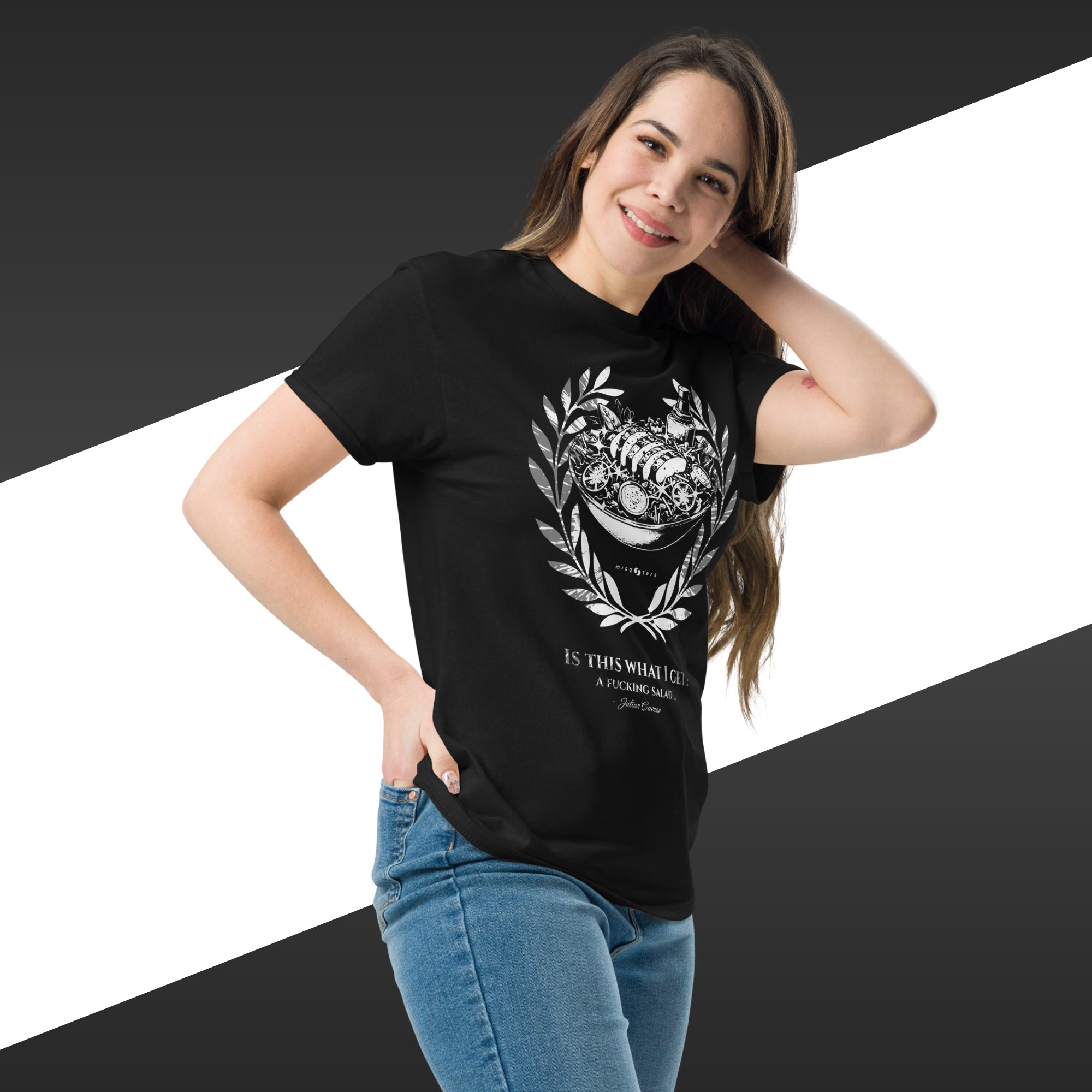 Woman wearing a black t-shirt with a graphic design and text, standing against a white and black striped background.