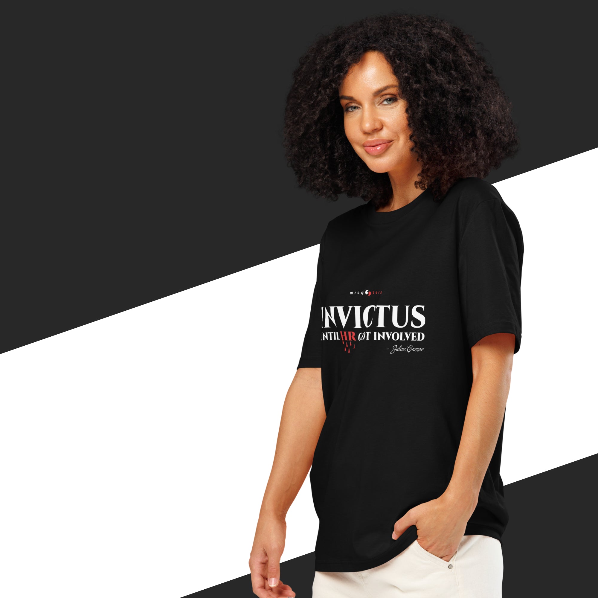Woman wearing a black t-shirt with 'Invictus' text on a black and white background