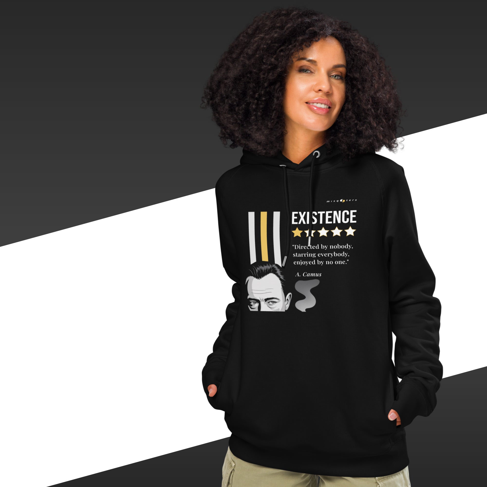 Person wearing a black hoodie with a quote and a face graphic on a black and white background