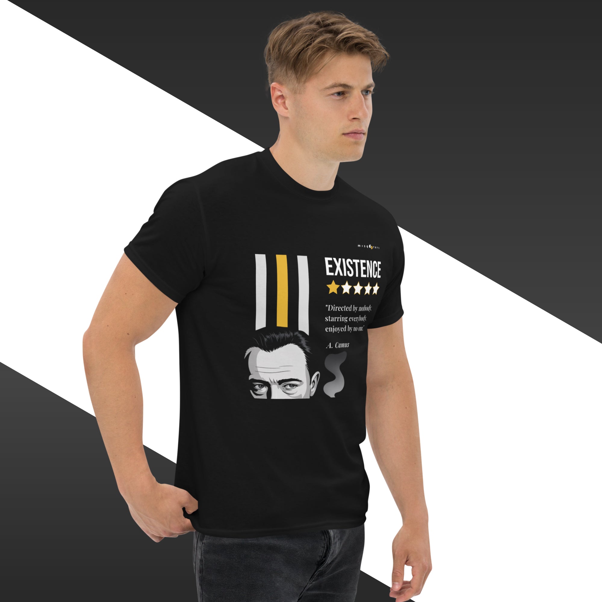Man wearing a black t-shirt with a graphic design and text, standing against a black and white background.