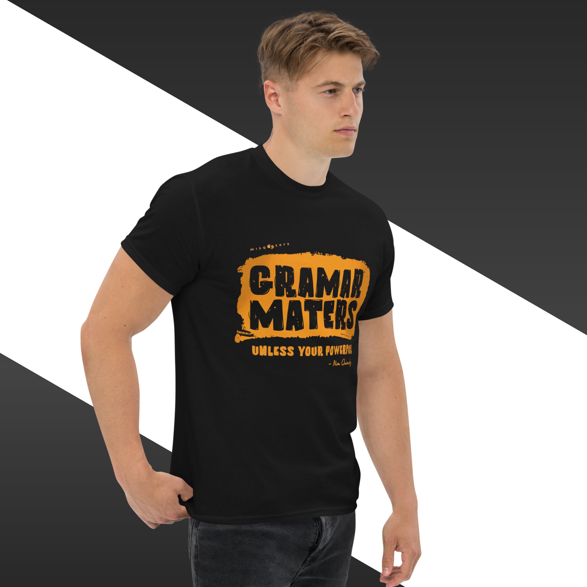 Man wearing a black t-shirt with yellow text on a geometric background
