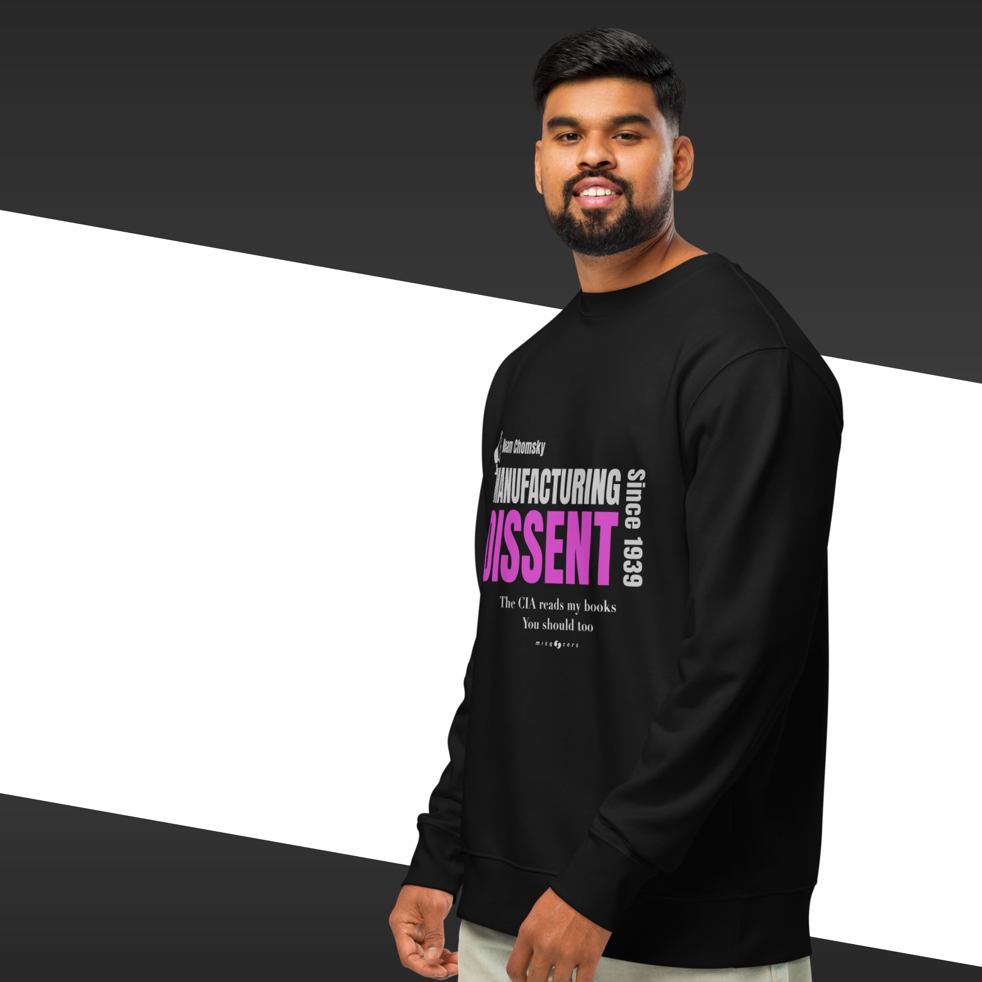 Man wearing a black sweatshirt with the quote "manufacturing dissent" from Noam Chomsky in purple
