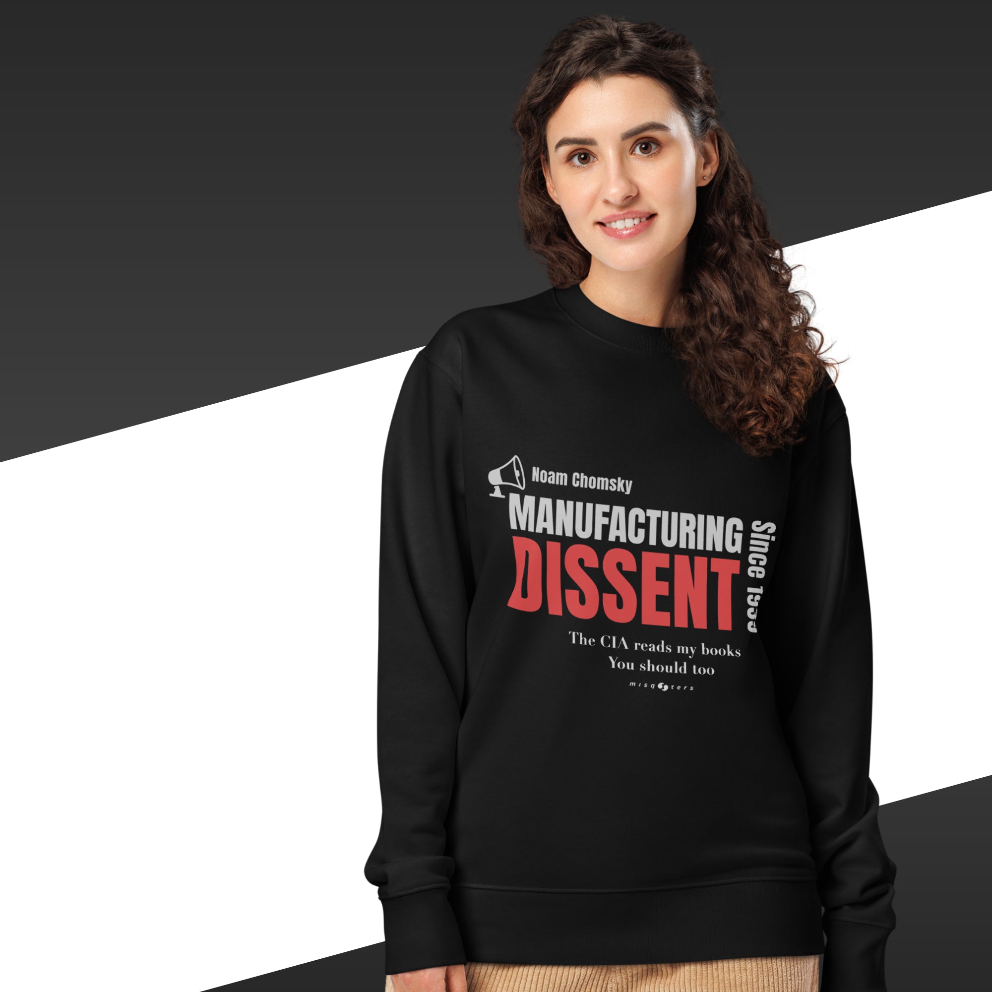 Woman wearing a black sweatshirt with the text "manufacturig dissent"
