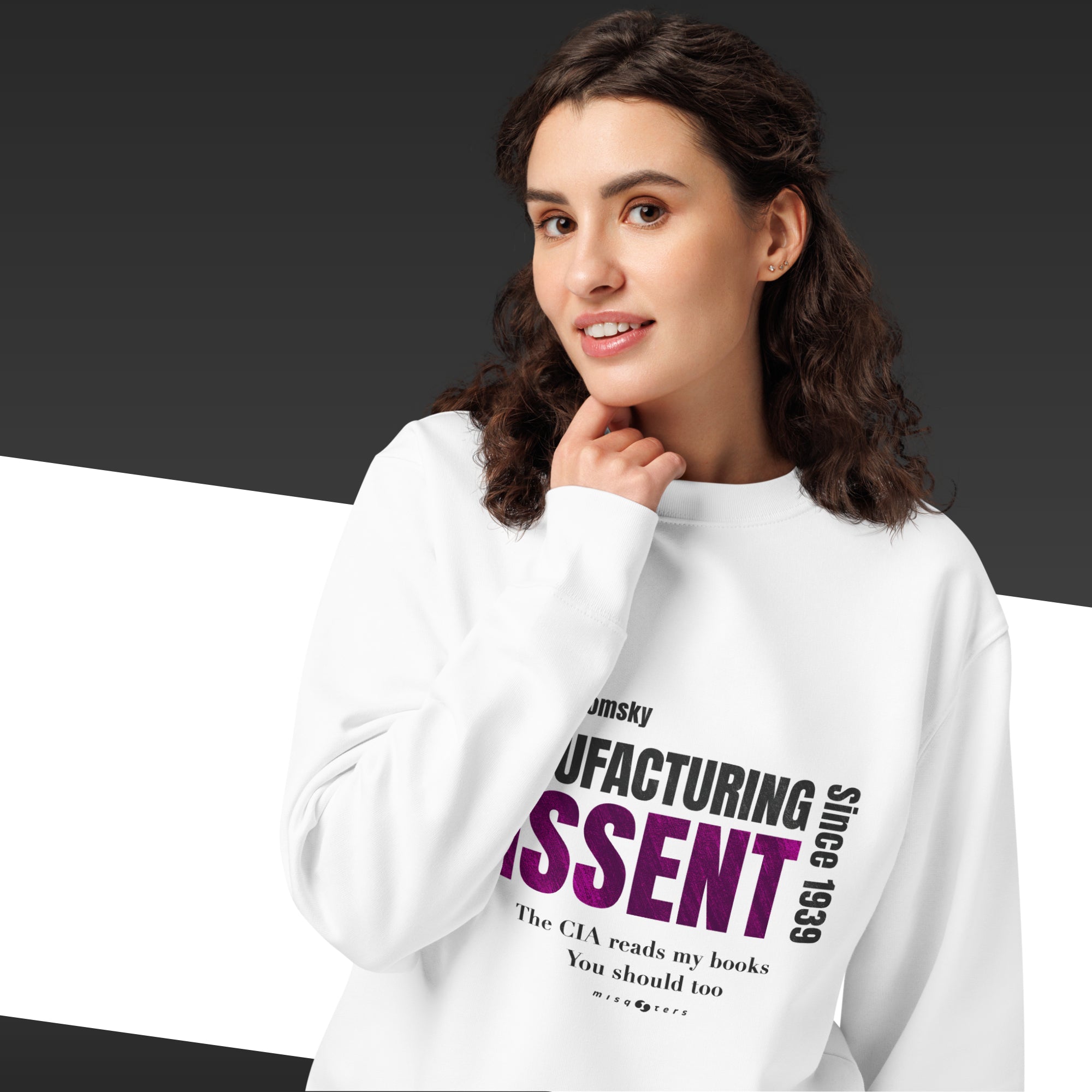 Woman wearing a white sweatshirt with the quote "manufacturing dissent" from Noam Chomsky in purple