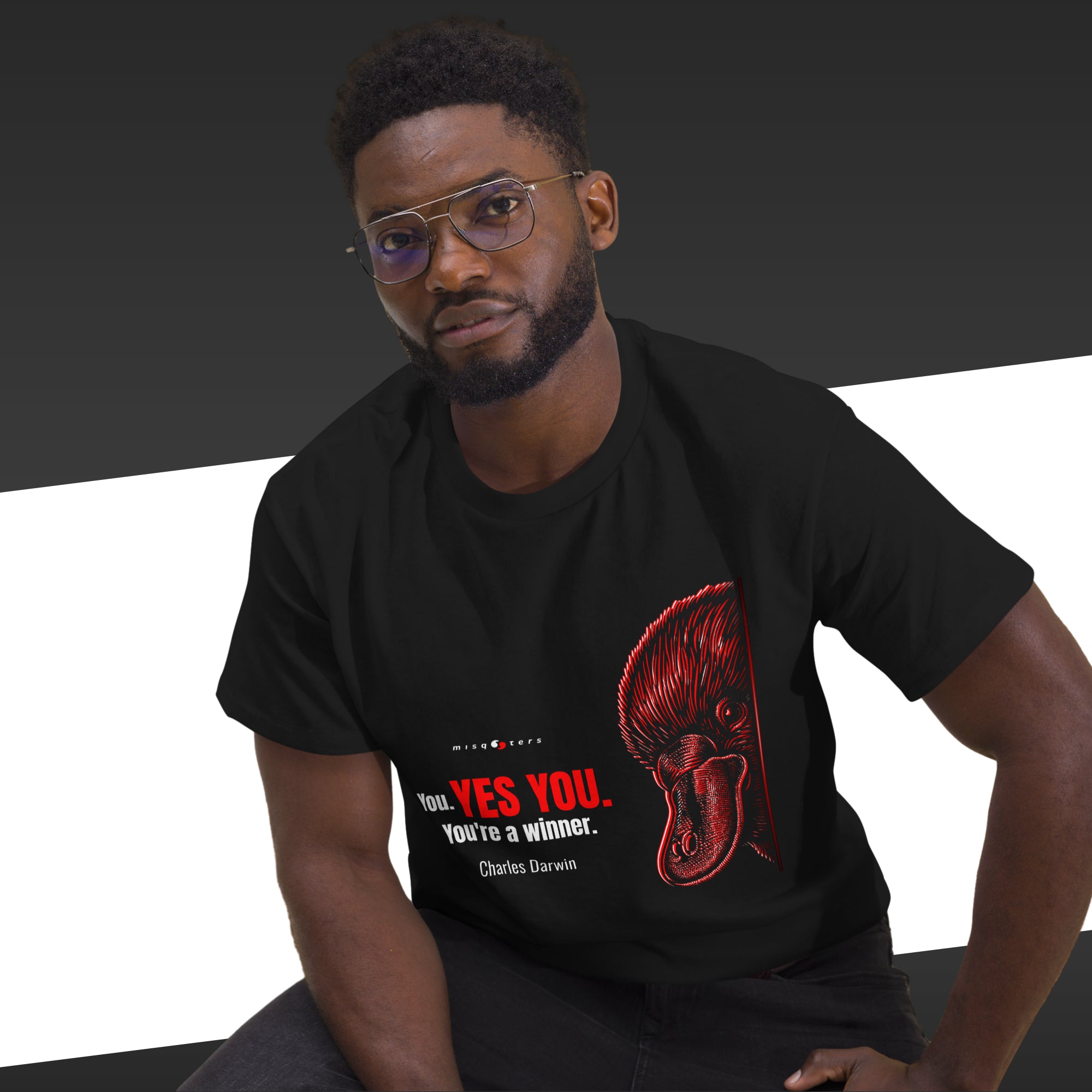 Man wearing a black t-shirt with a red graphic and text on a dark background