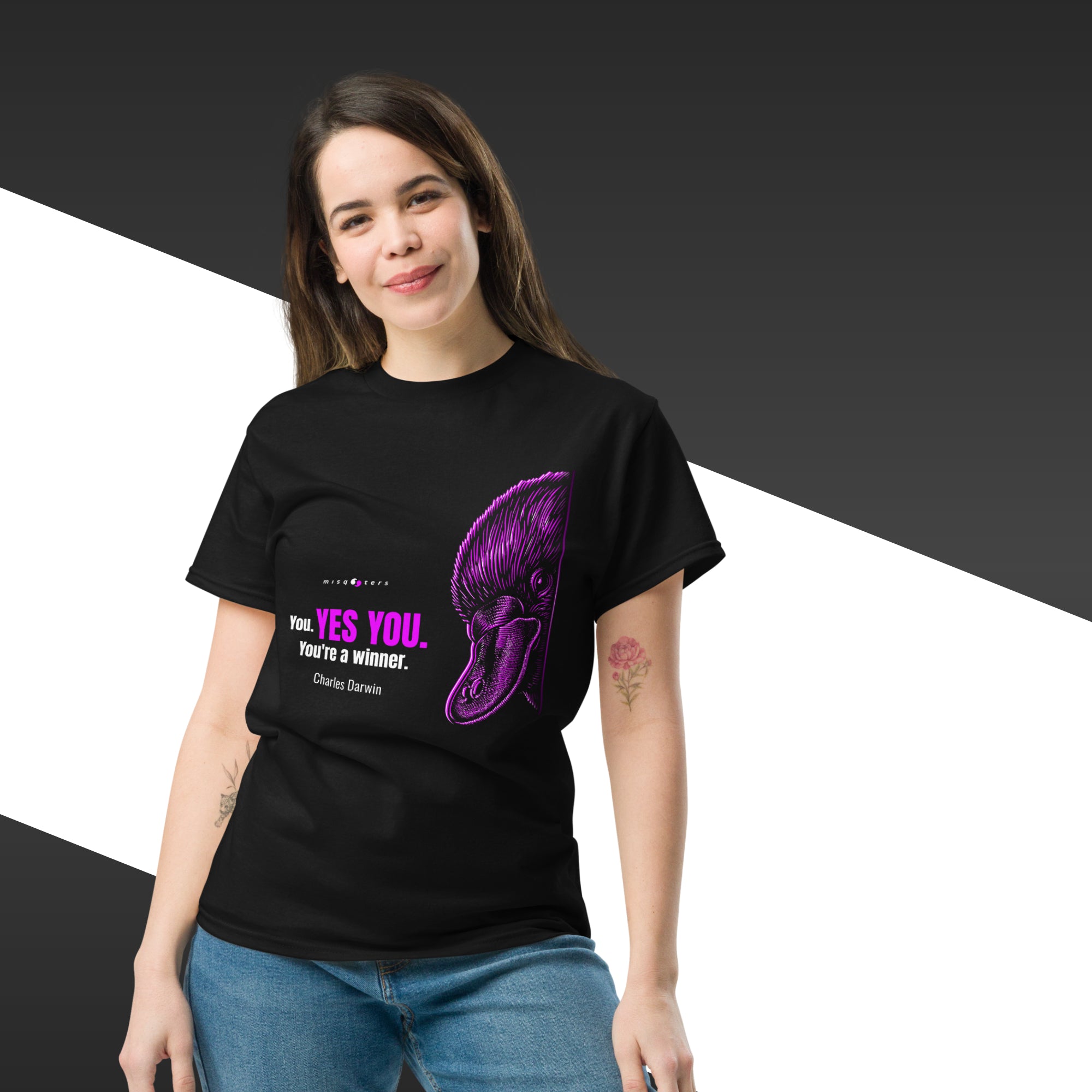 Person wearing a black t-shirt with a purple graphic and text on a black and white background