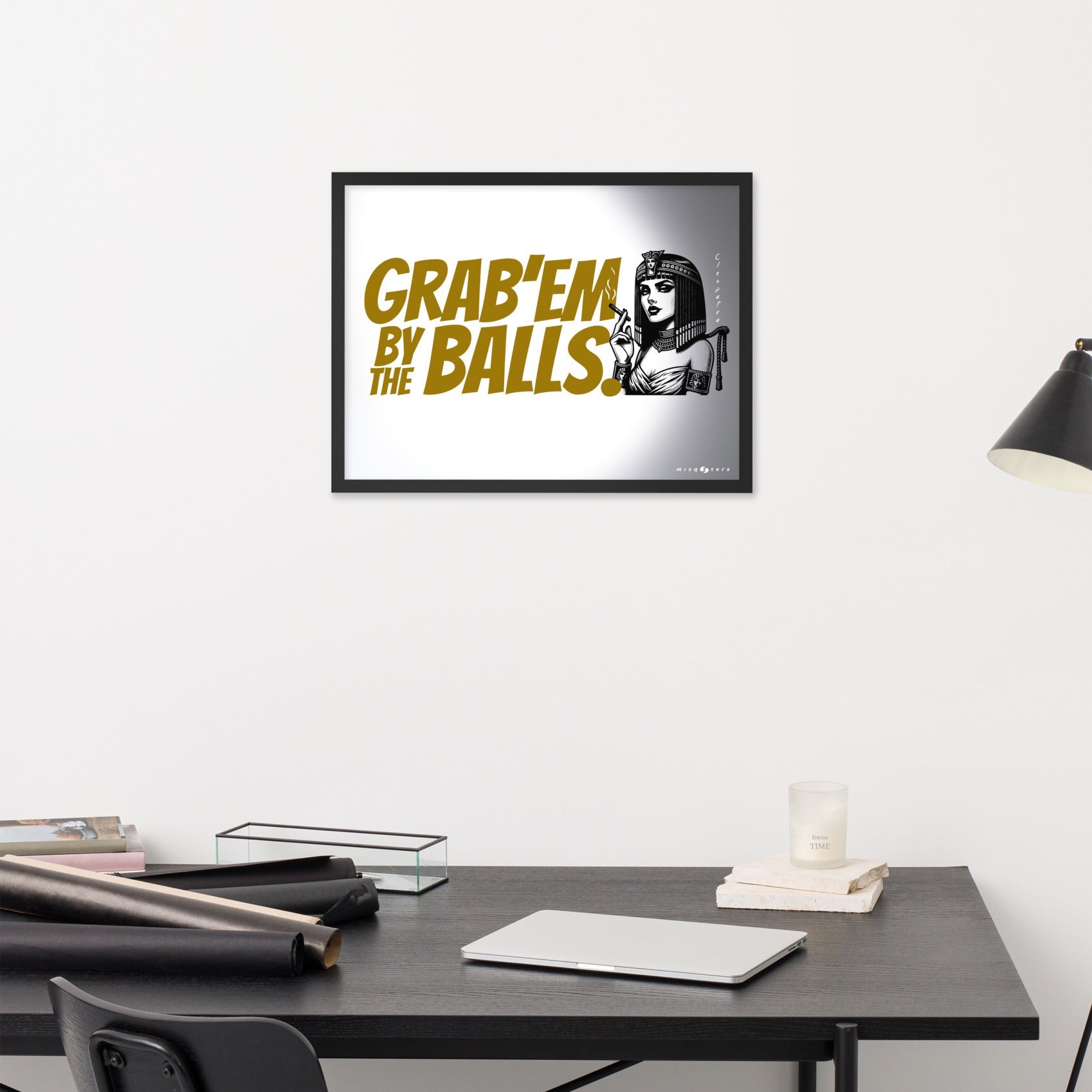 Framed artwork with text and a graphic of a woman on a wall above a desk.