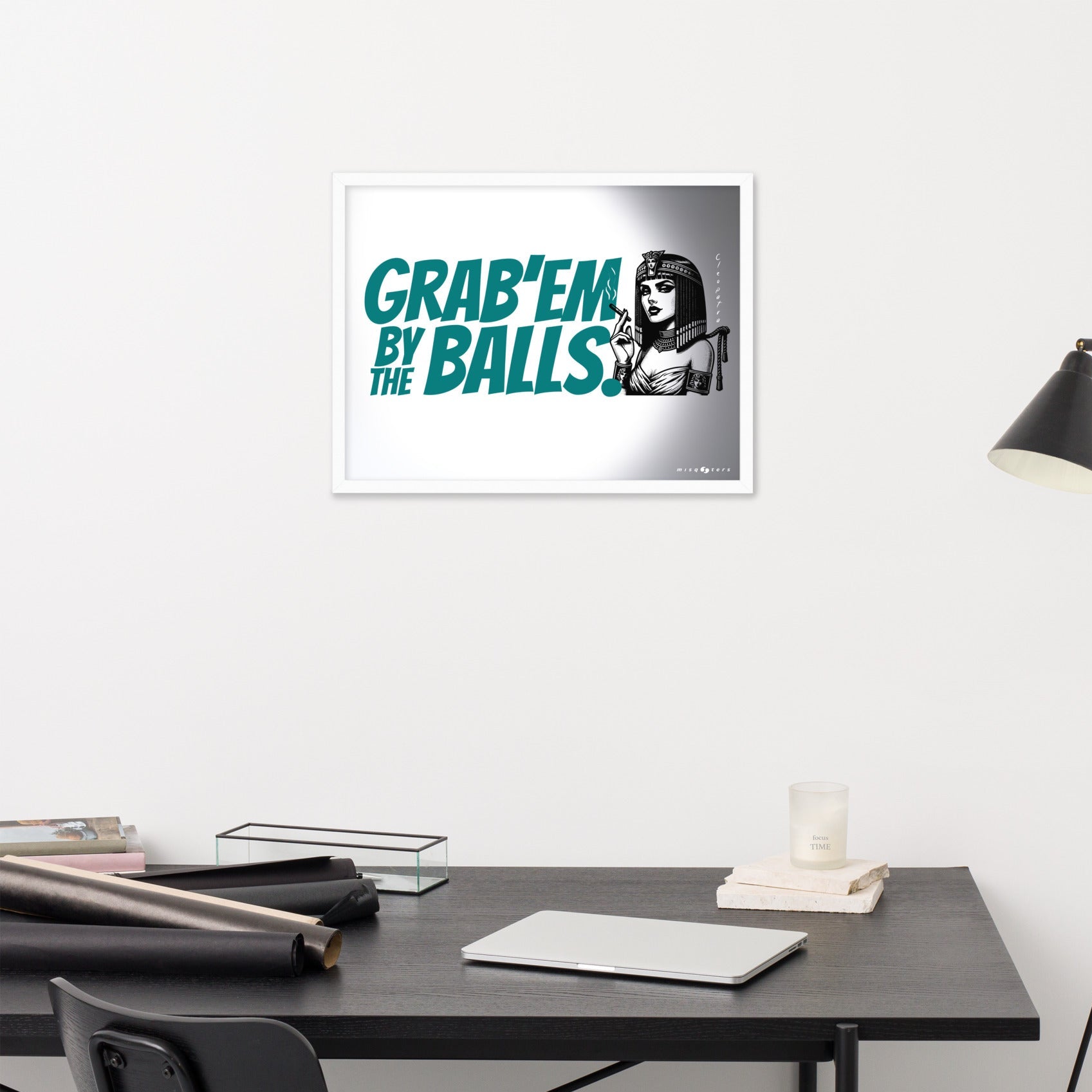 Framed artwork with text and a graphic of a woman on a wall above a desk.