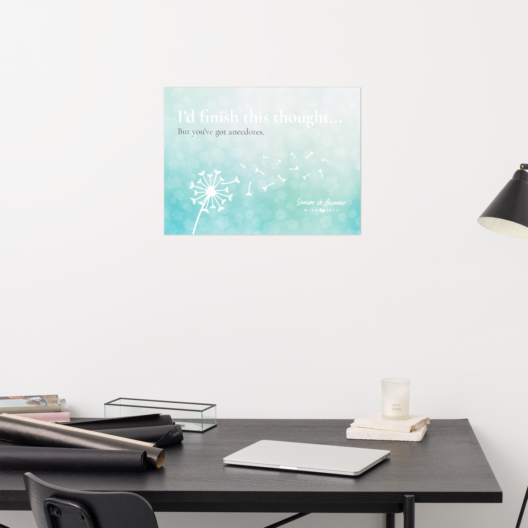 Desk with a poster featuring a dandelion on a light blue background.