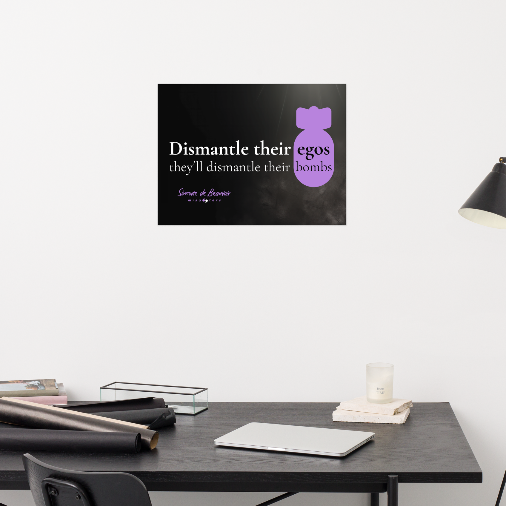 Modern office setup with a desk, chair, and lamp against a white wall with a simone de beavoir femenist poster.