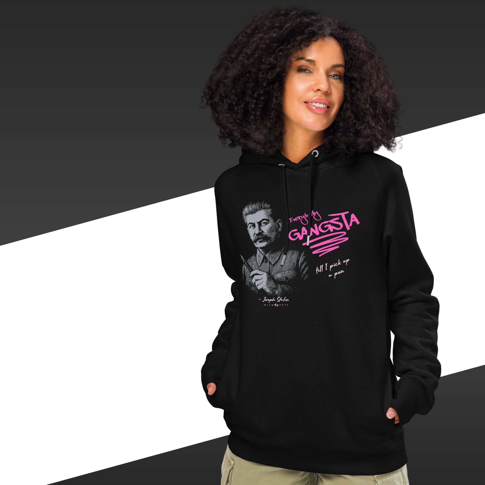 Person wearing a black hoodie with a graphic design and text, standing against a black and white background.