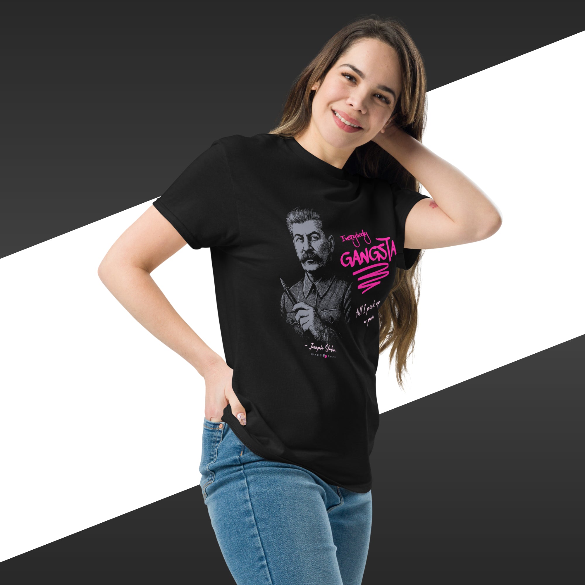 Woman wearing a black t-shirt with a graphic design on a white and black striped background