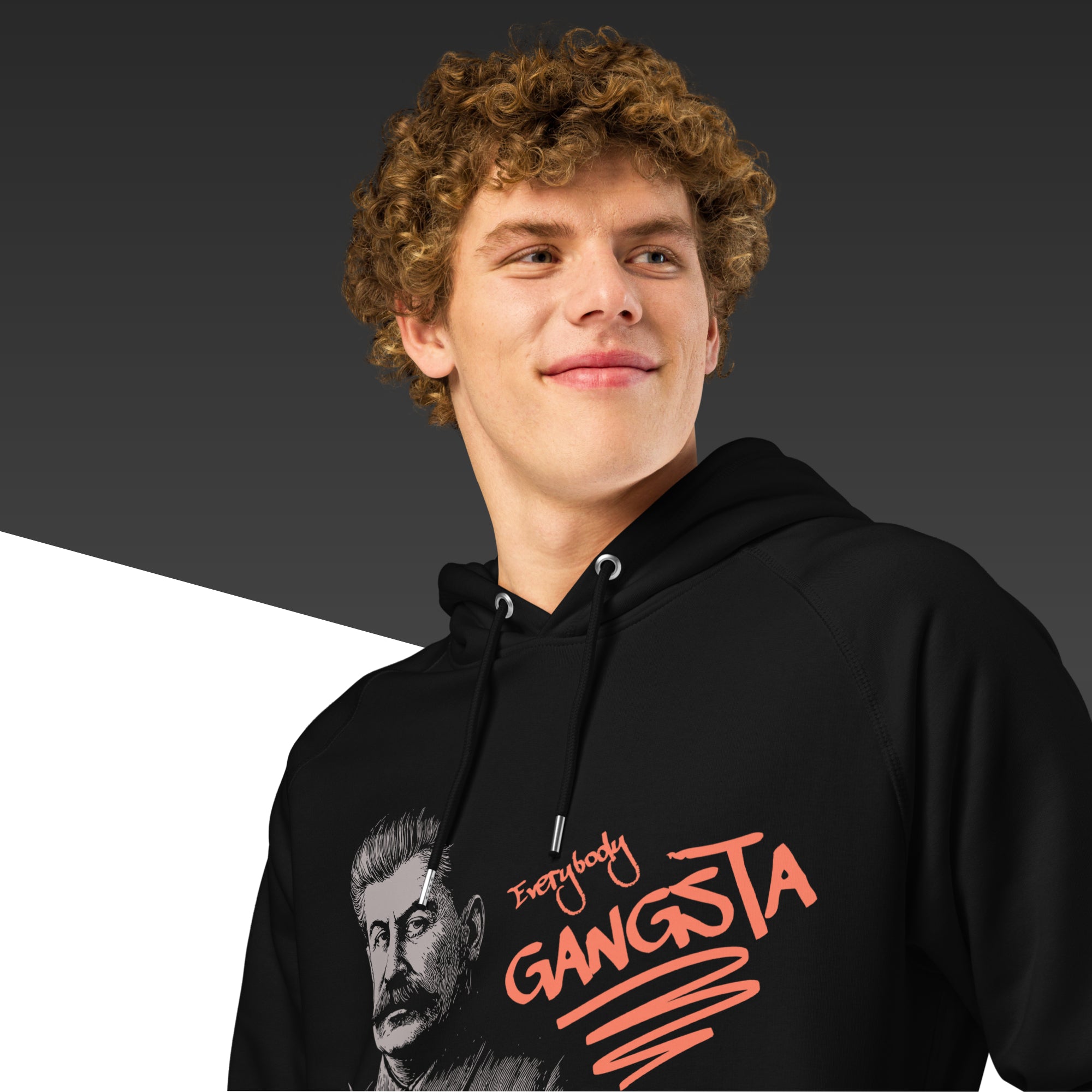 Person wearing a black hoodie with text and a graphic design on a dark background