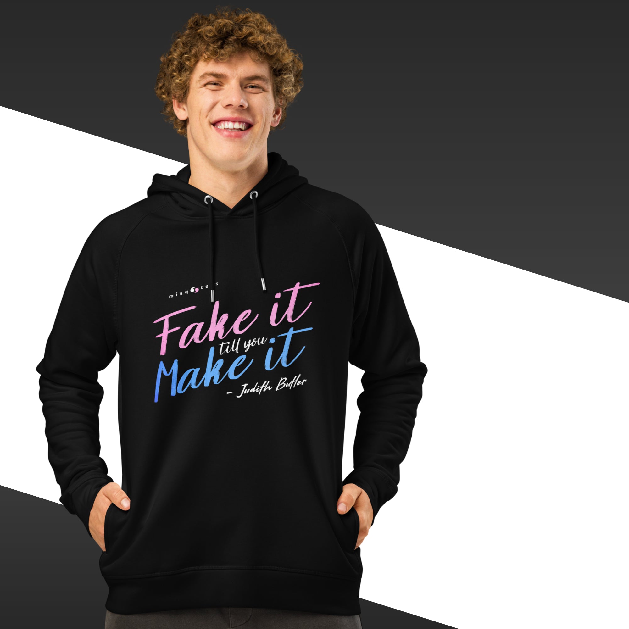 Person wearing a black hoodie with colorful text on a black and white background