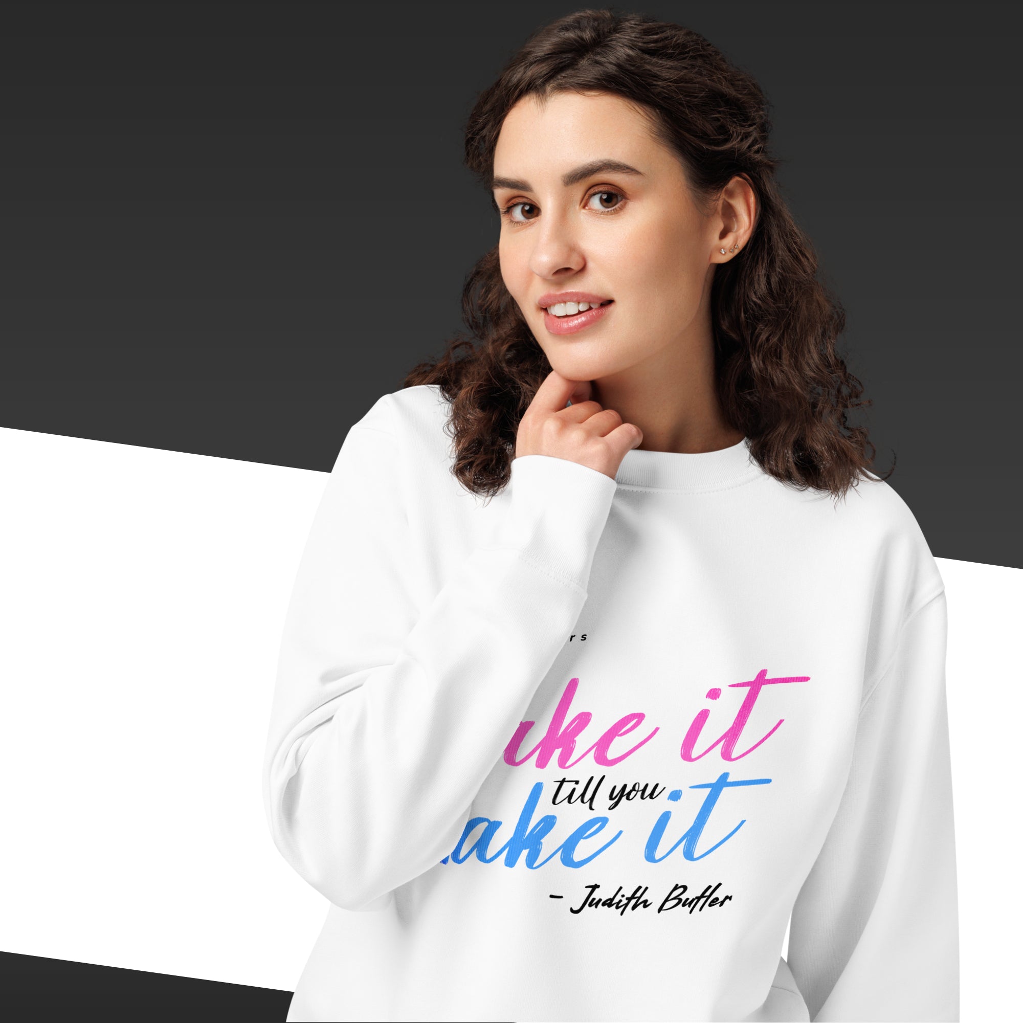Woman wearing a white sweatshirt with colorful text and a quote on a gradient background