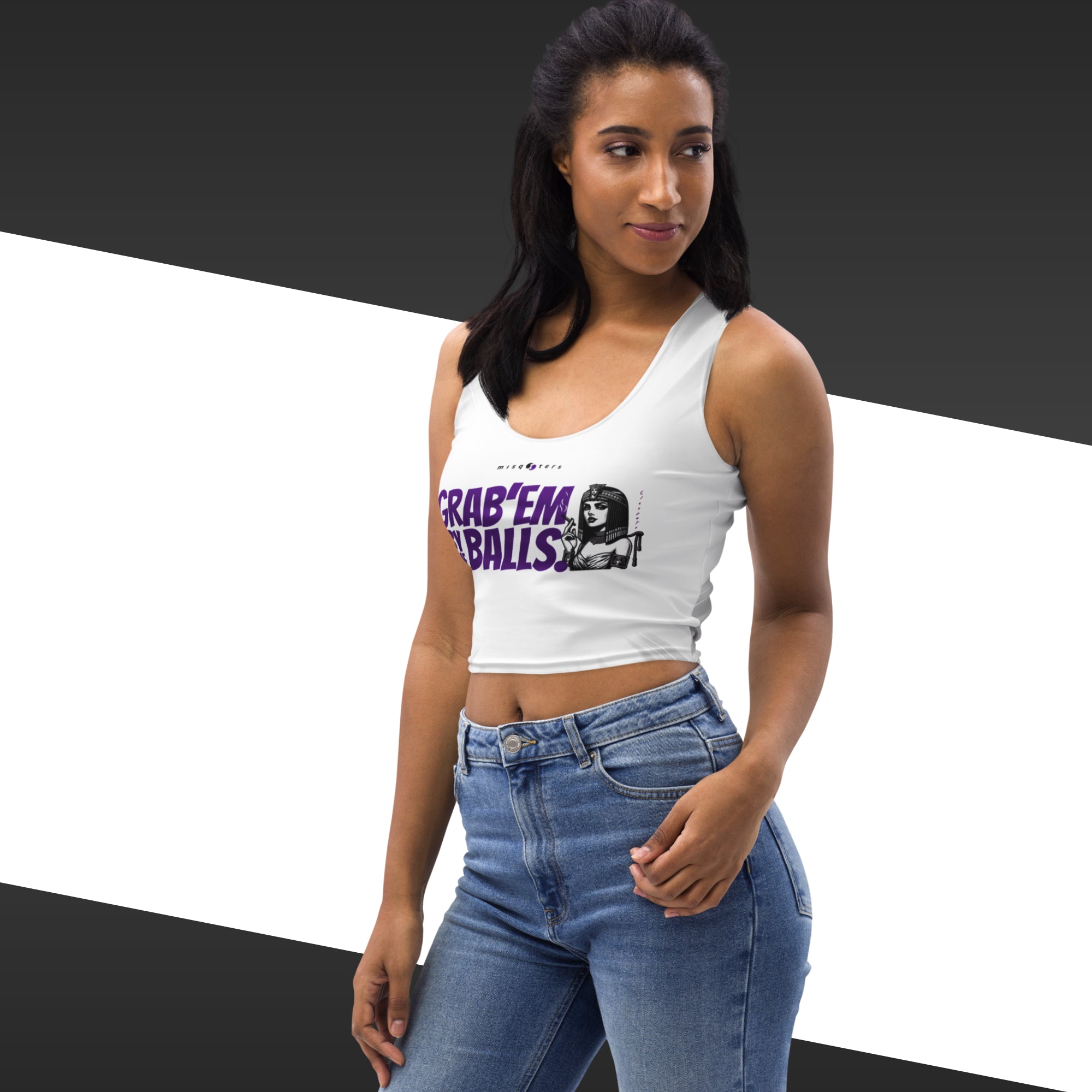 Woman wearing a white tank top with graphic design and text, standing against a black and white background.