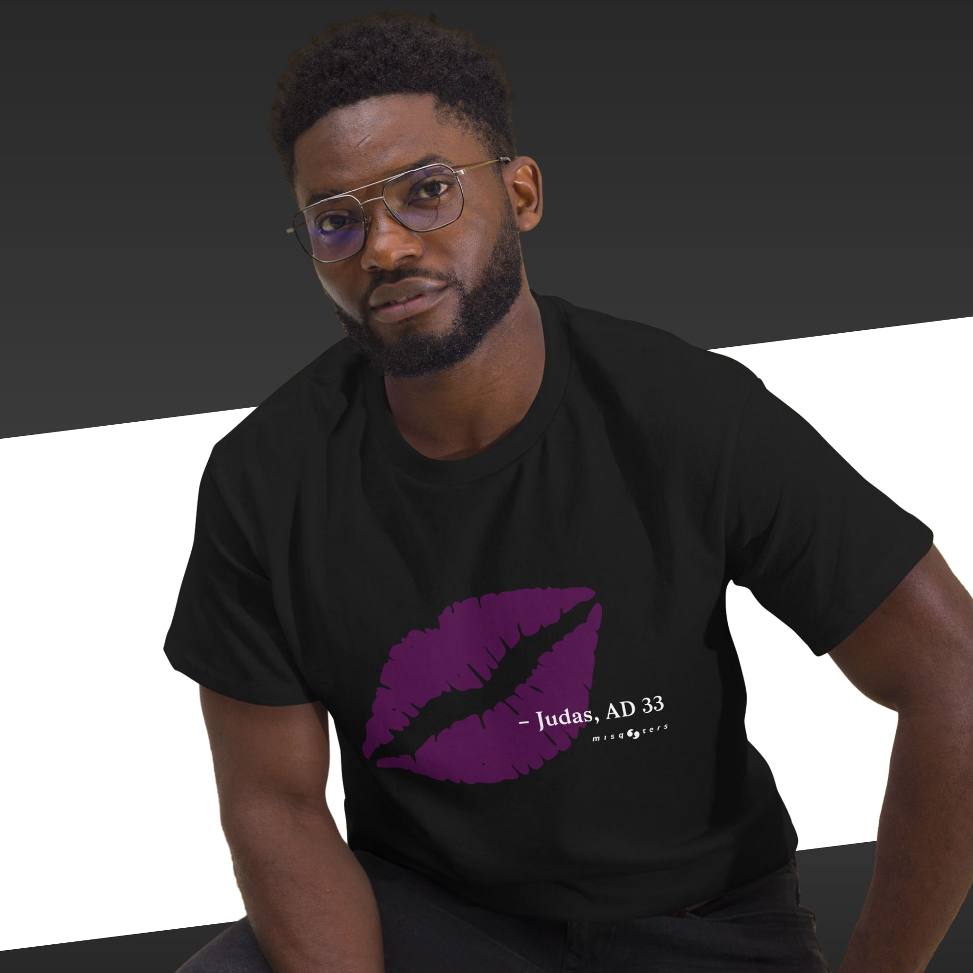 Man wearing a black t-shirt with a purple graphic and text