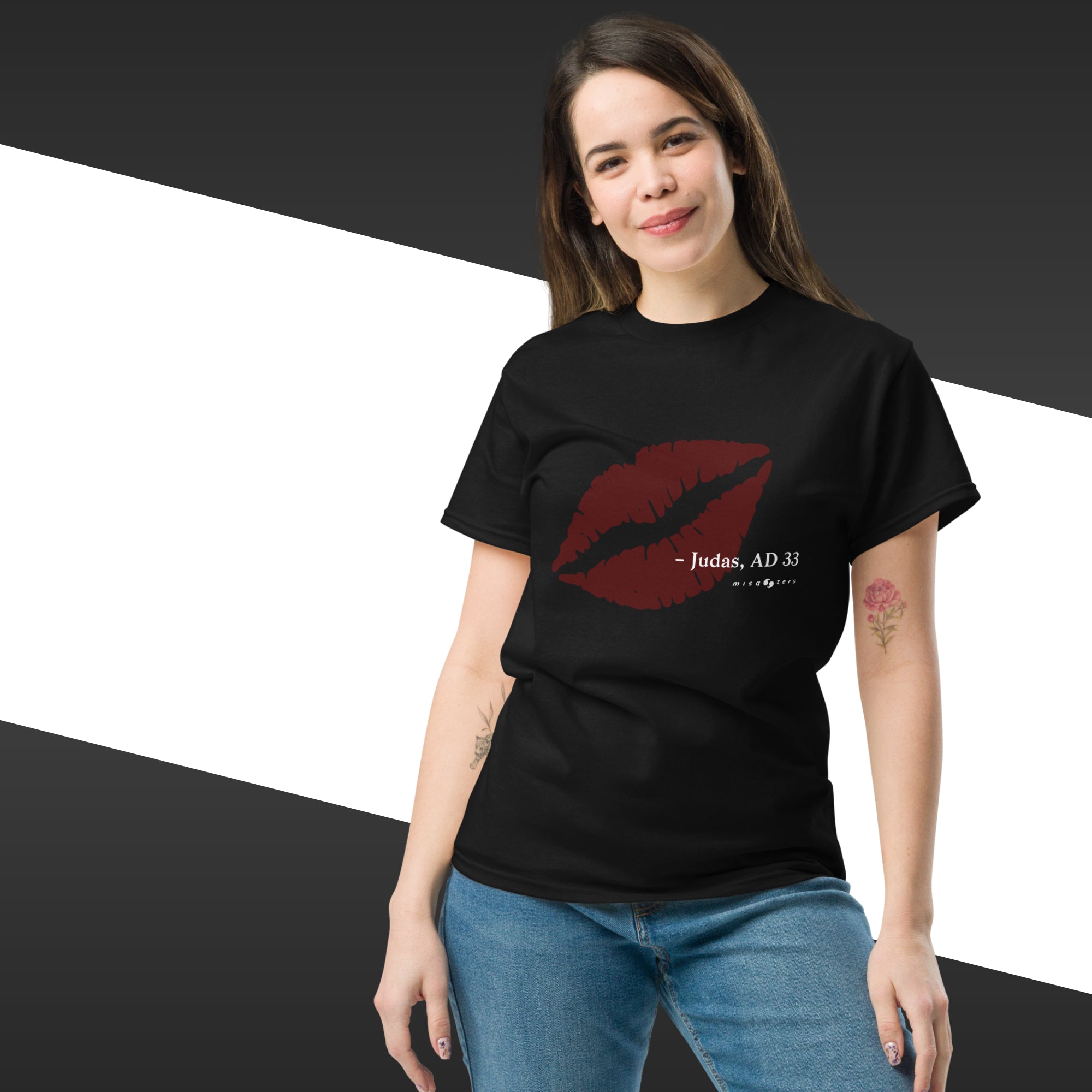 Woman wearing a black t-shirt with a red lip graphic and text, standing against a black and white background.