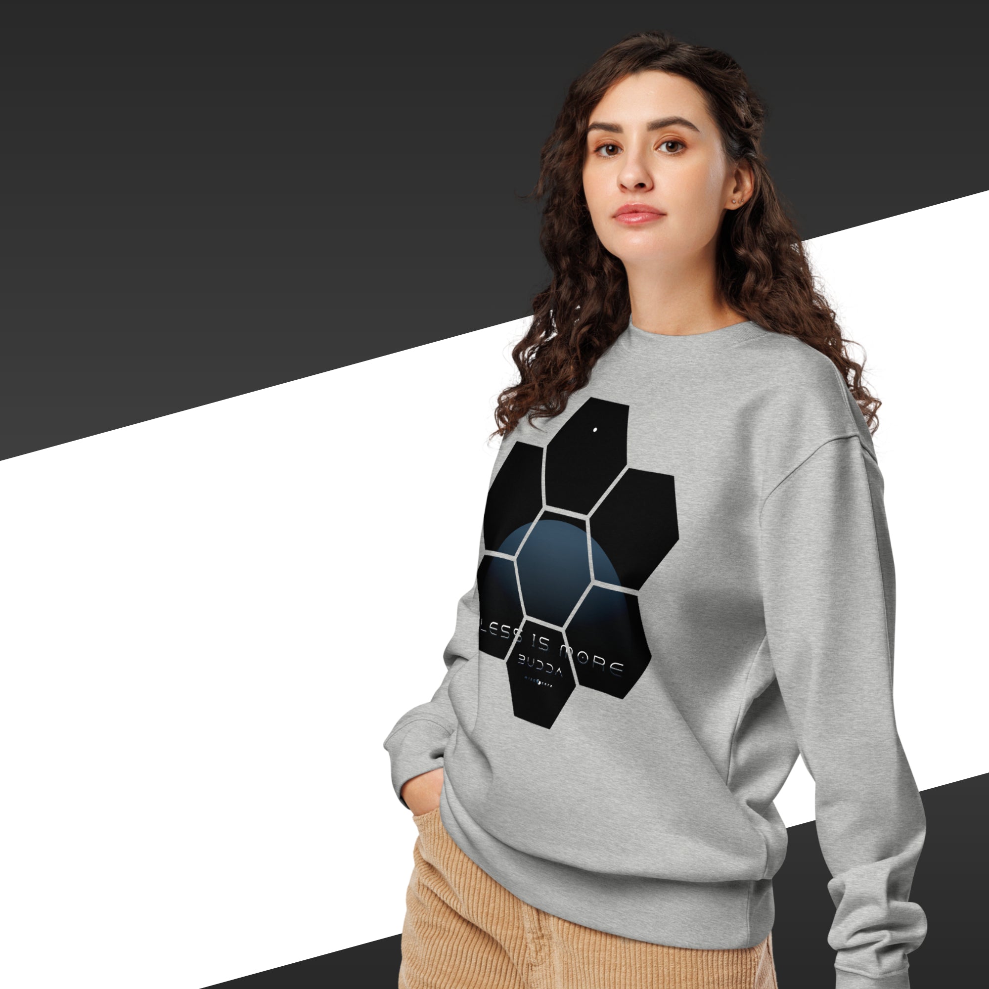 Woman wearing a gray sweatshirt with a geometric design on a black and white background