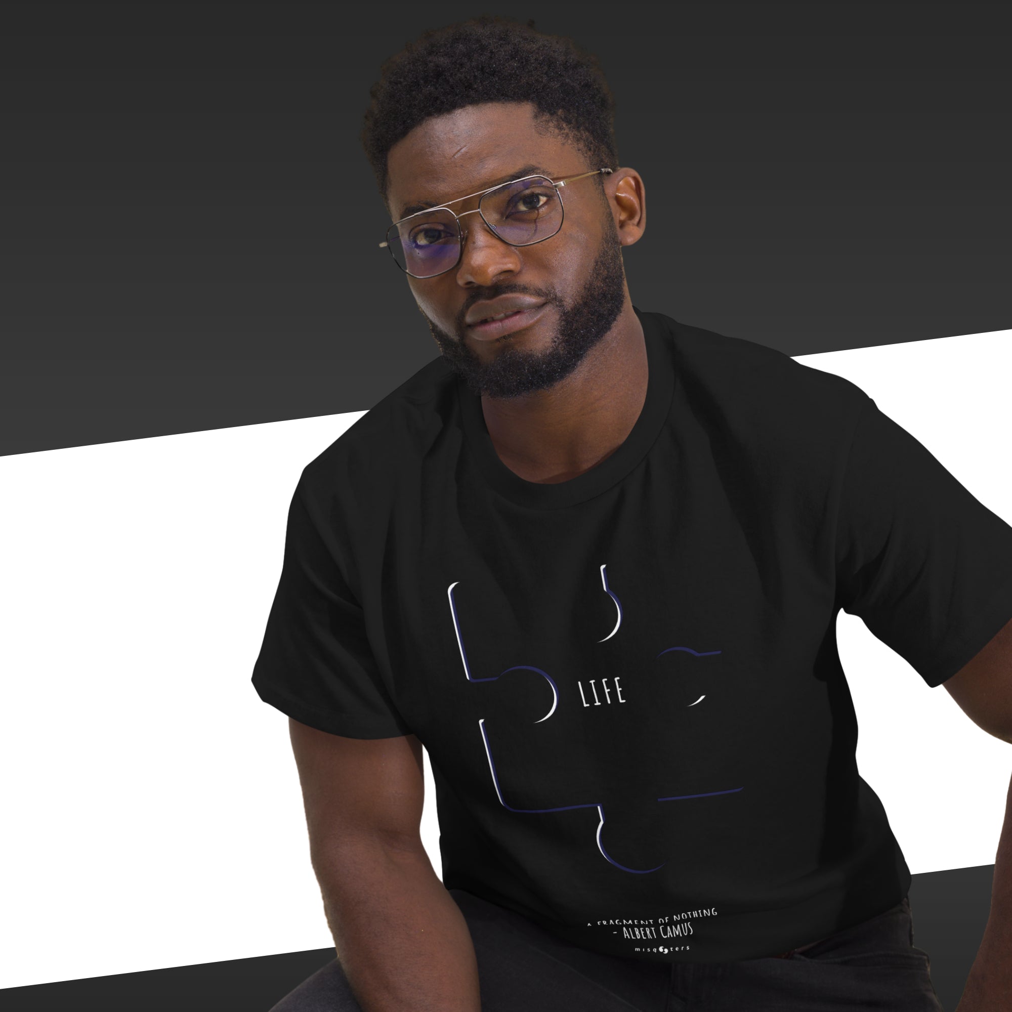 Man wearing a black t-shirt with a graphic design on a white background