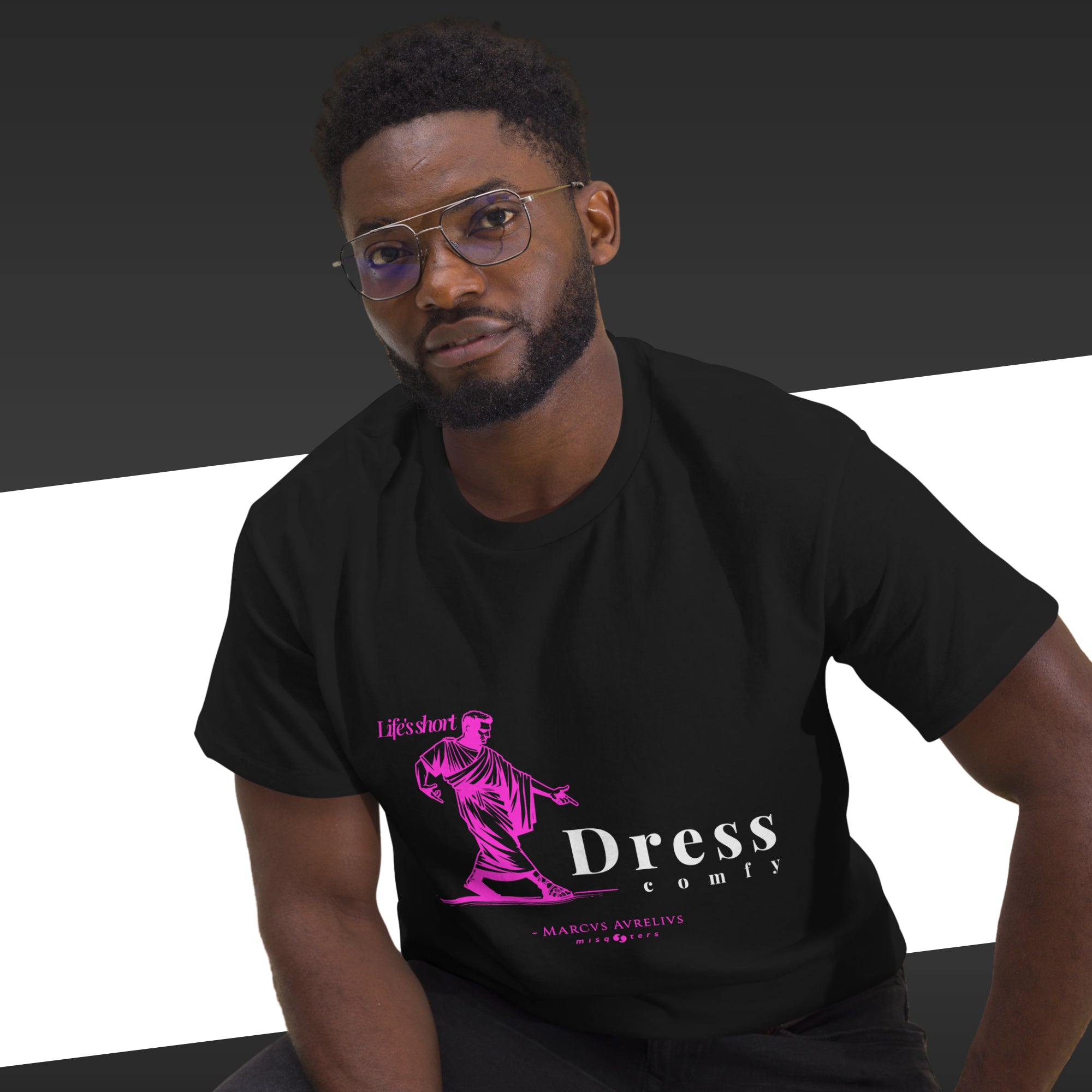 Man wearing a black t-shirt with a pink and white graphic design on a black and white background