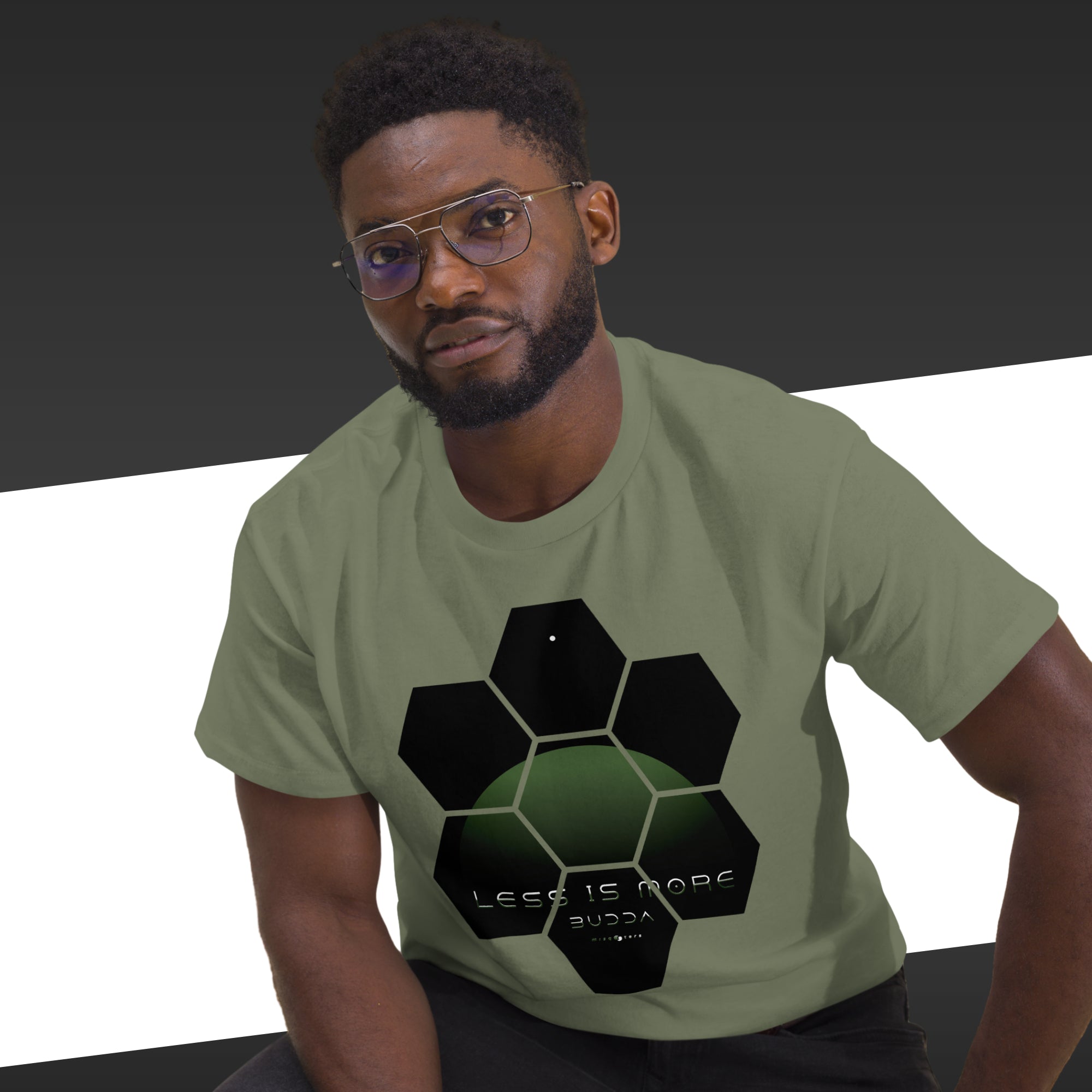 Man wearing a green t-shirt with a black geometric design and text.