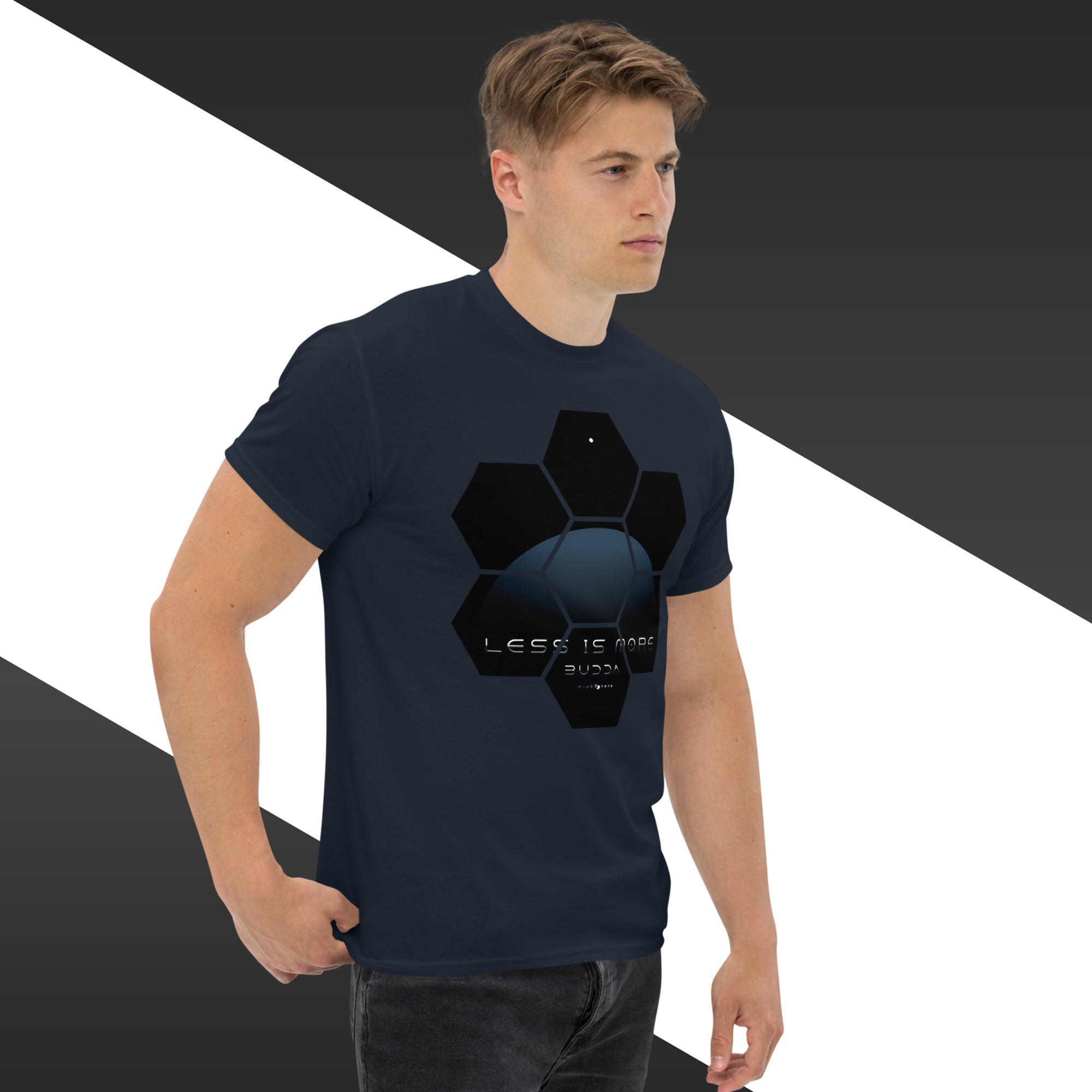 Man wearing a navy blue t-shirt with a black geometric design on a white and gray background