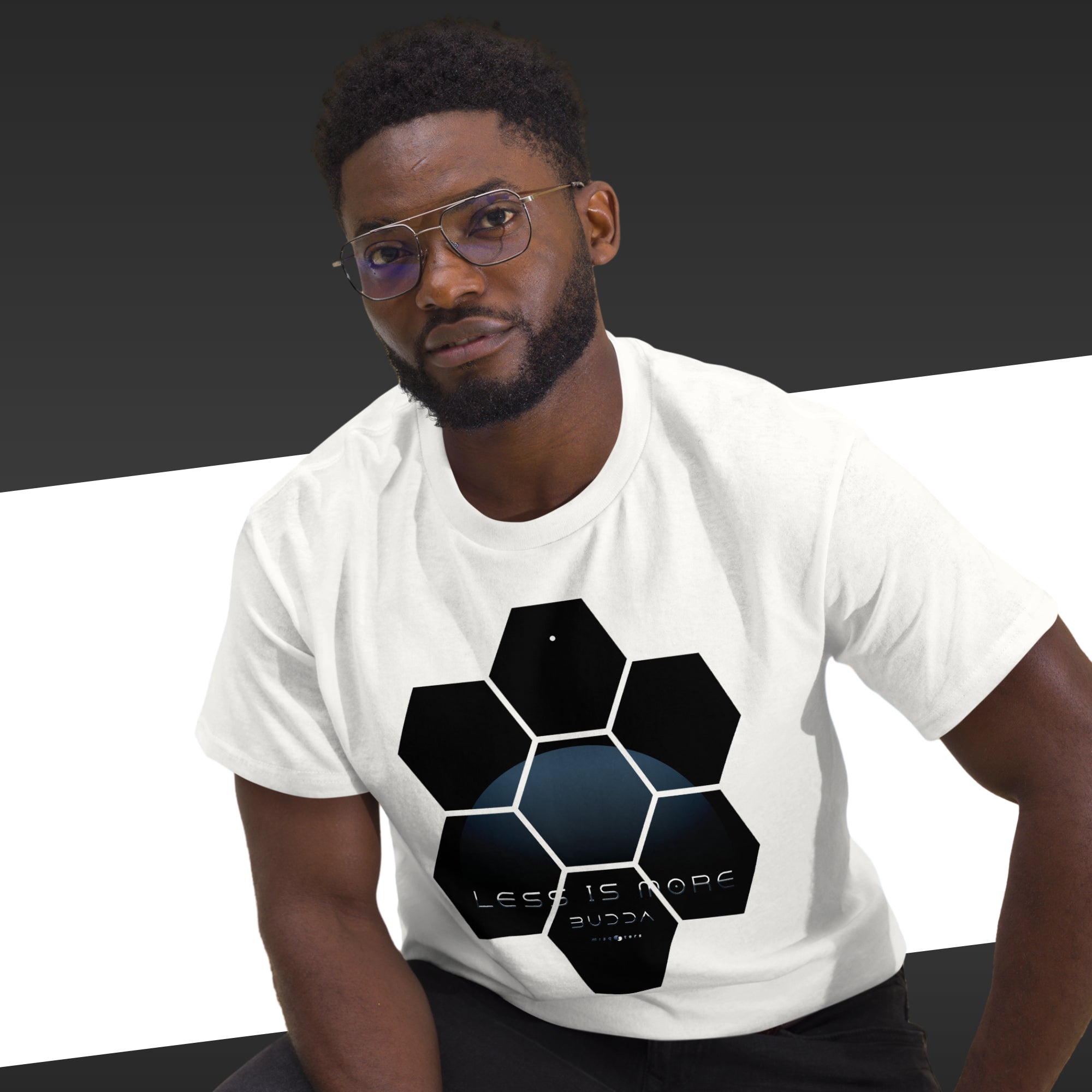 Man wearing a white t-shirt with a black geometric design on a dark background