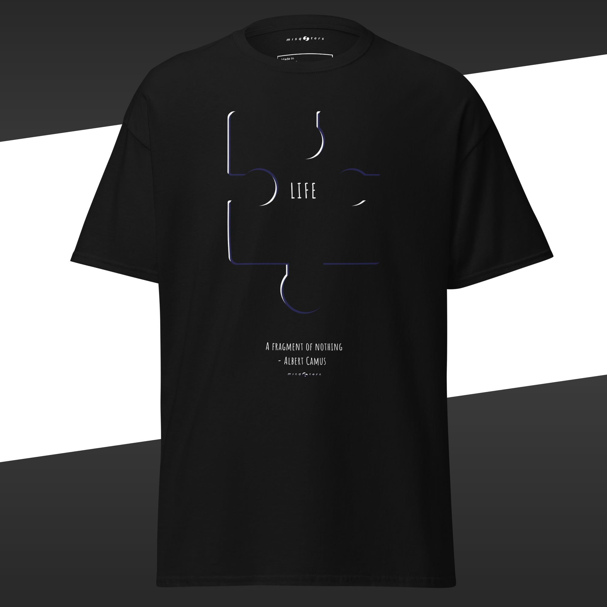 Black t-shirt with abstract design of a puzzle with the work "Life" on it and the fake quote "A fragment by nothing" by Albert Camus below