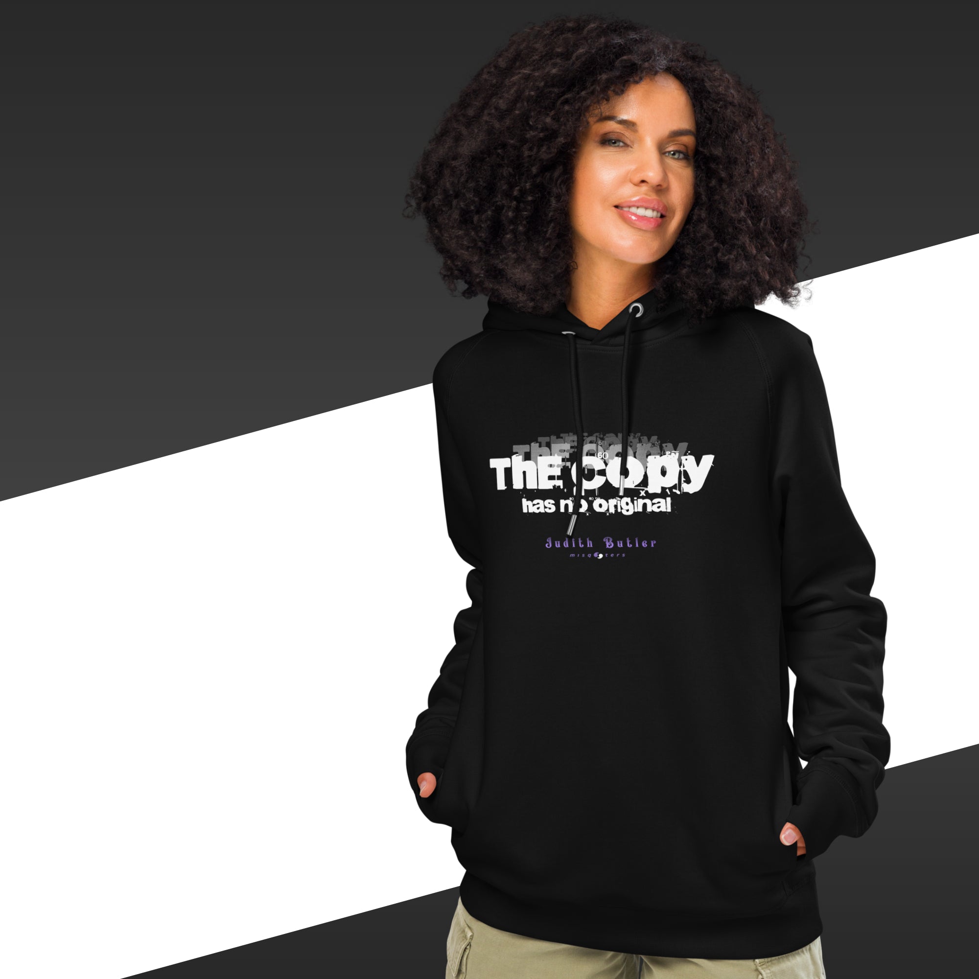Person wearing a black hoodie with text design on a black and white background
