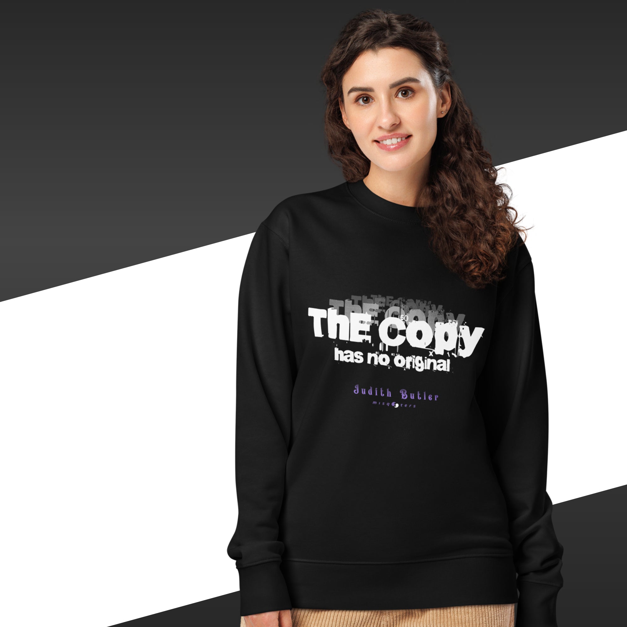 Woman wearing a black sweatshirt with white text on a black and white background