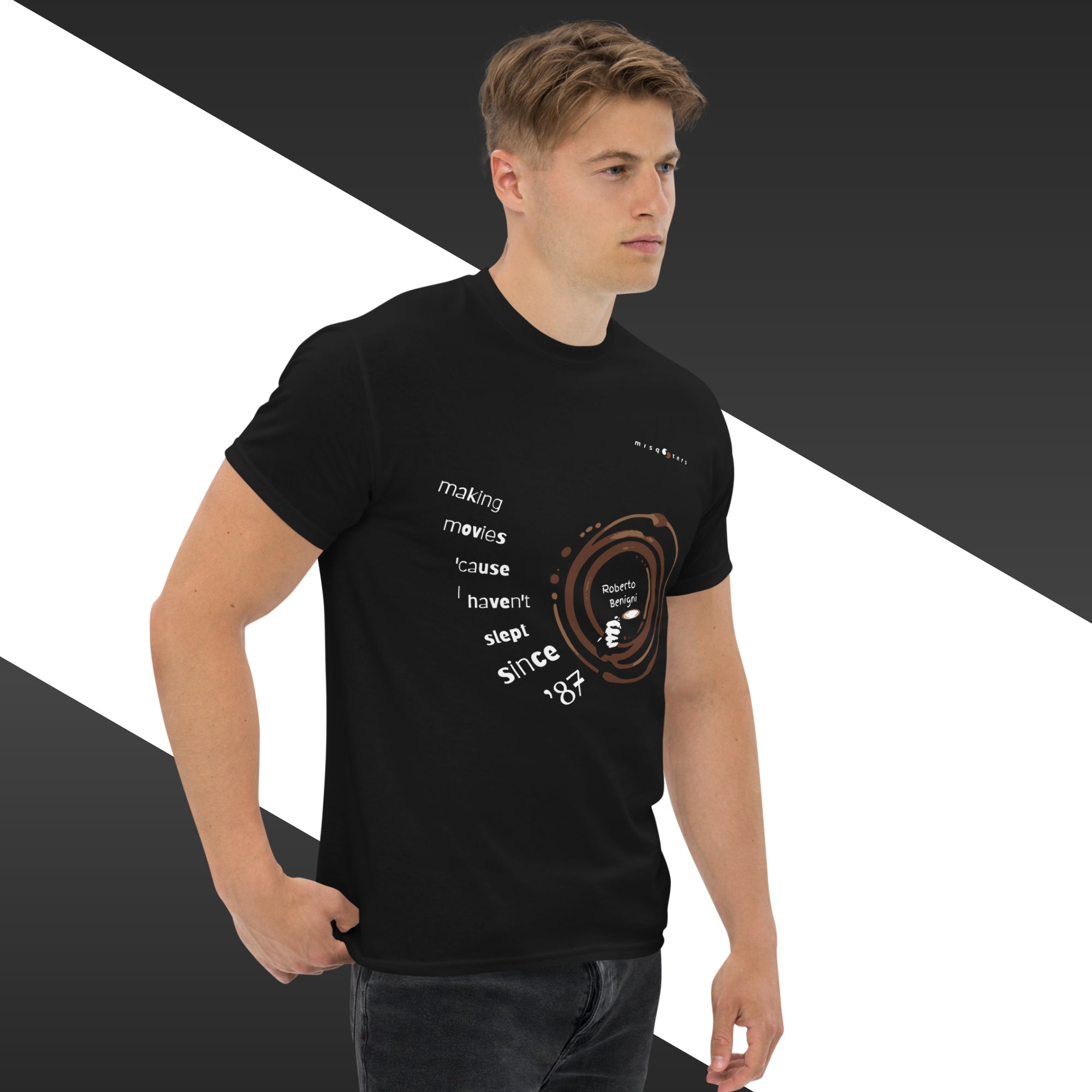 Man wearing a black t-shirt with text and graphics on a white and gray background