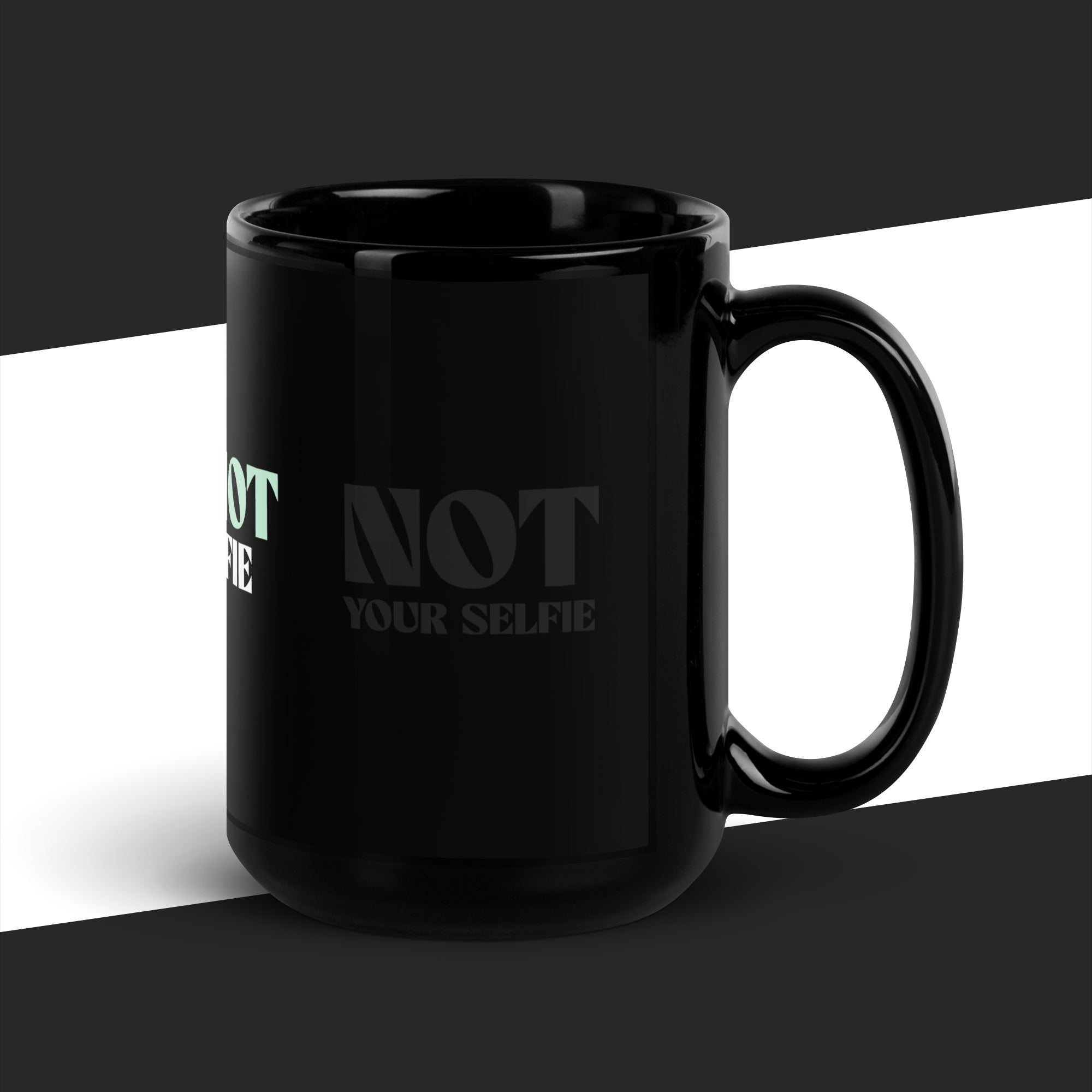 Black mug with text 'NOT YOUR SELFIE' on a black and white background