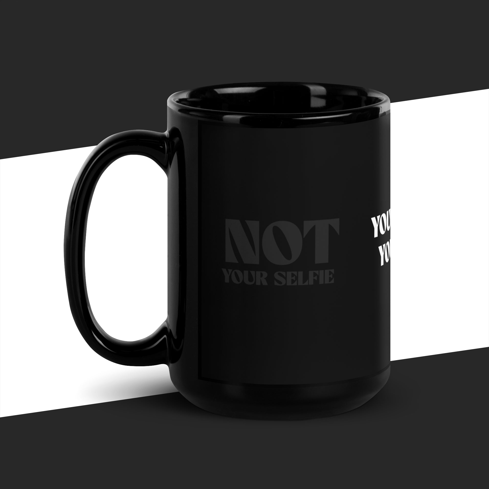 Black mug with 'NOT YOUR SELFIE' text on a black and white background
