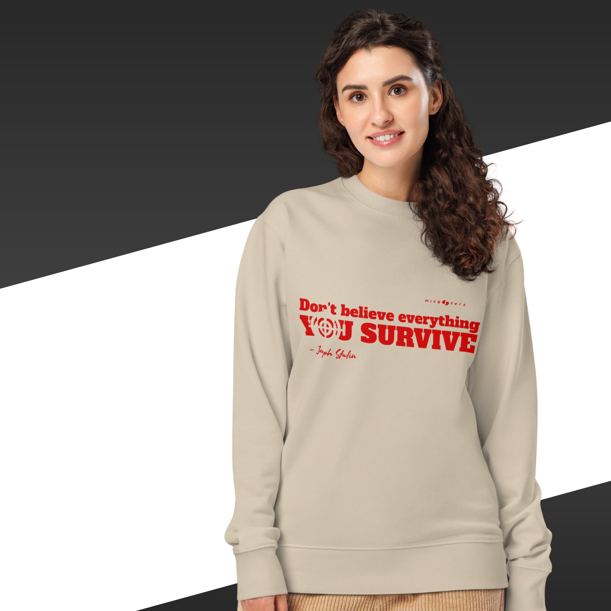 Woman wearing a beige sweatshirt with red text on a black and white background